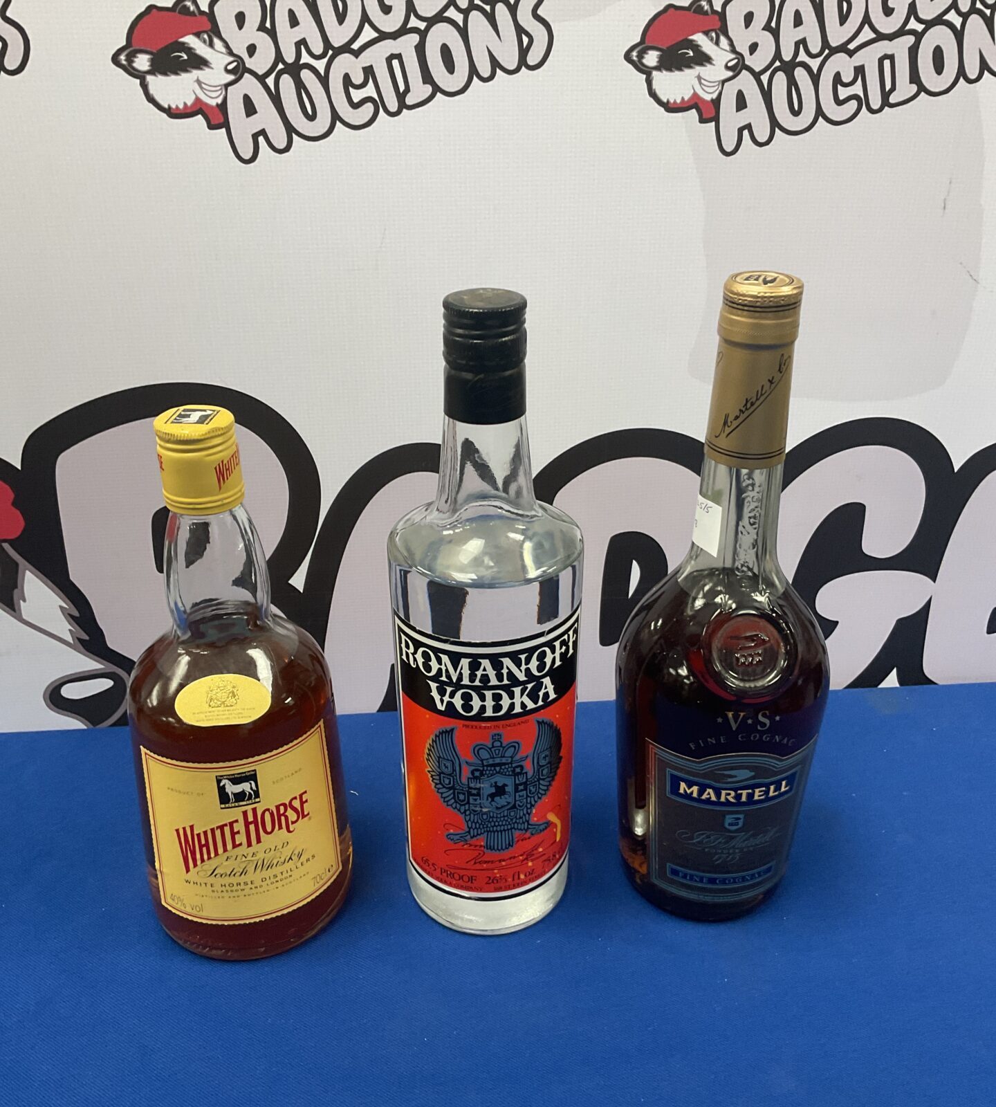 Three bottles of alcohol including romanoff vodka & white horse whiskey