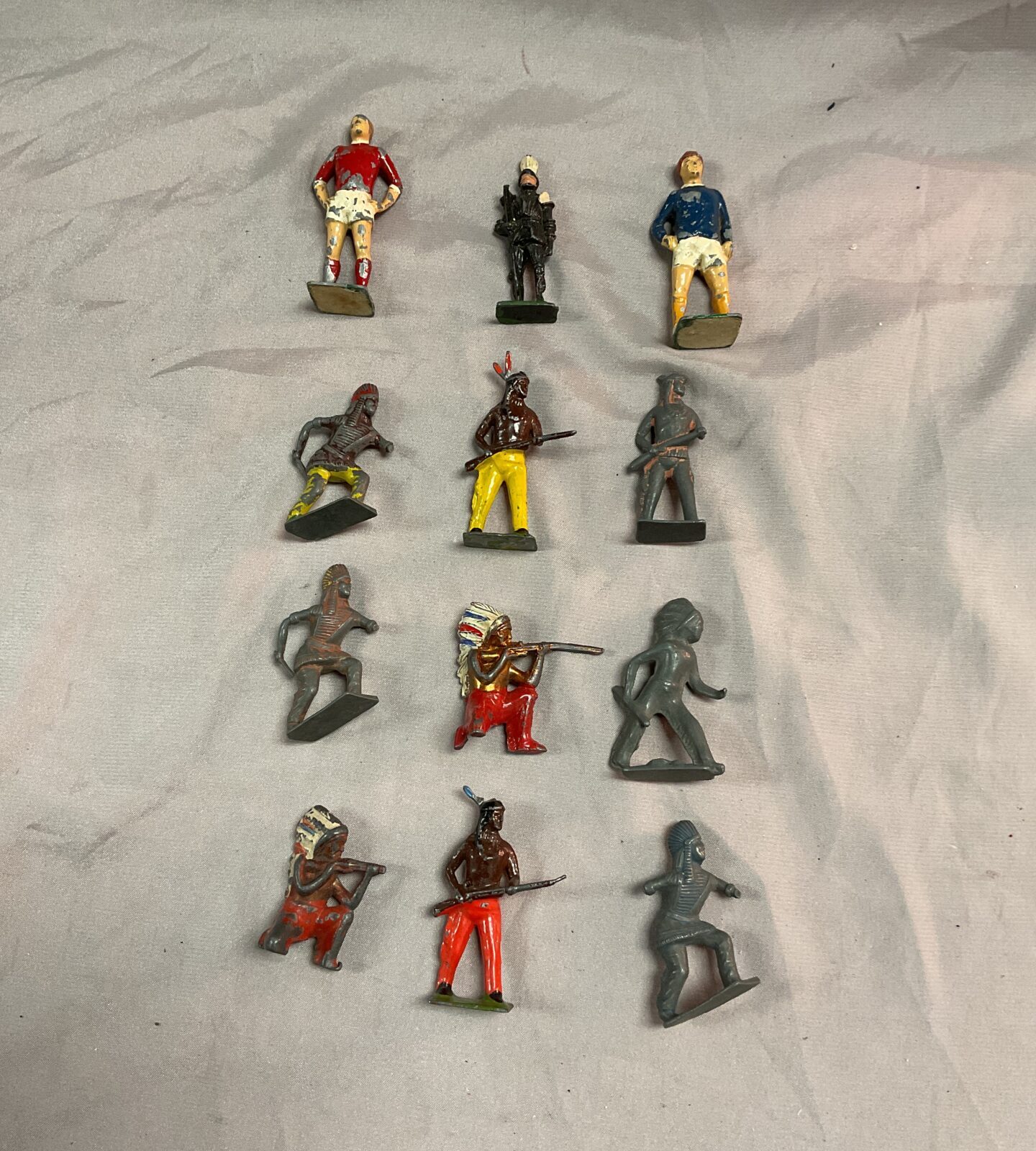 box of lead Indian figures inc football players