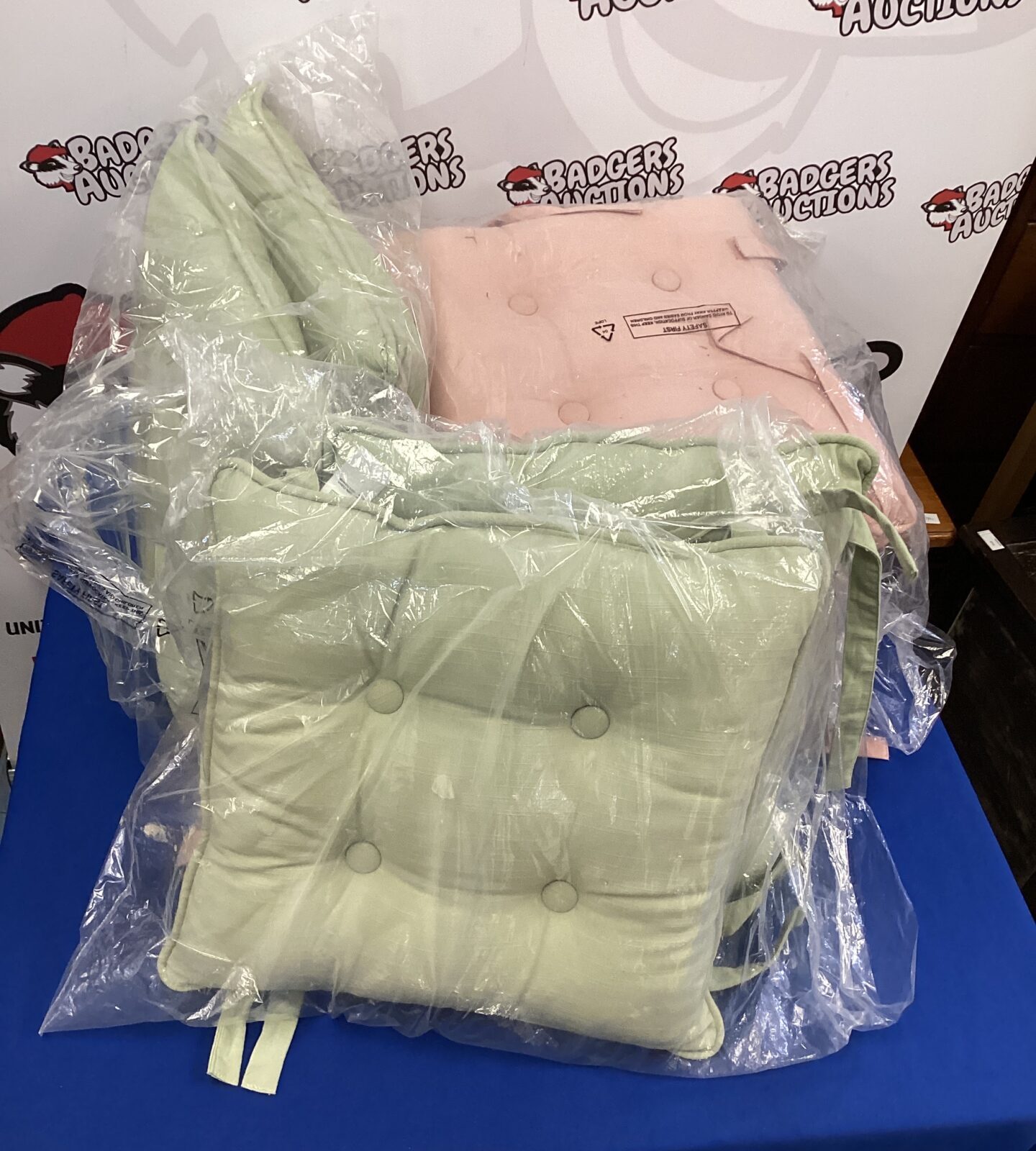 Quantity of pink & olive coloured dunelm seat cushions