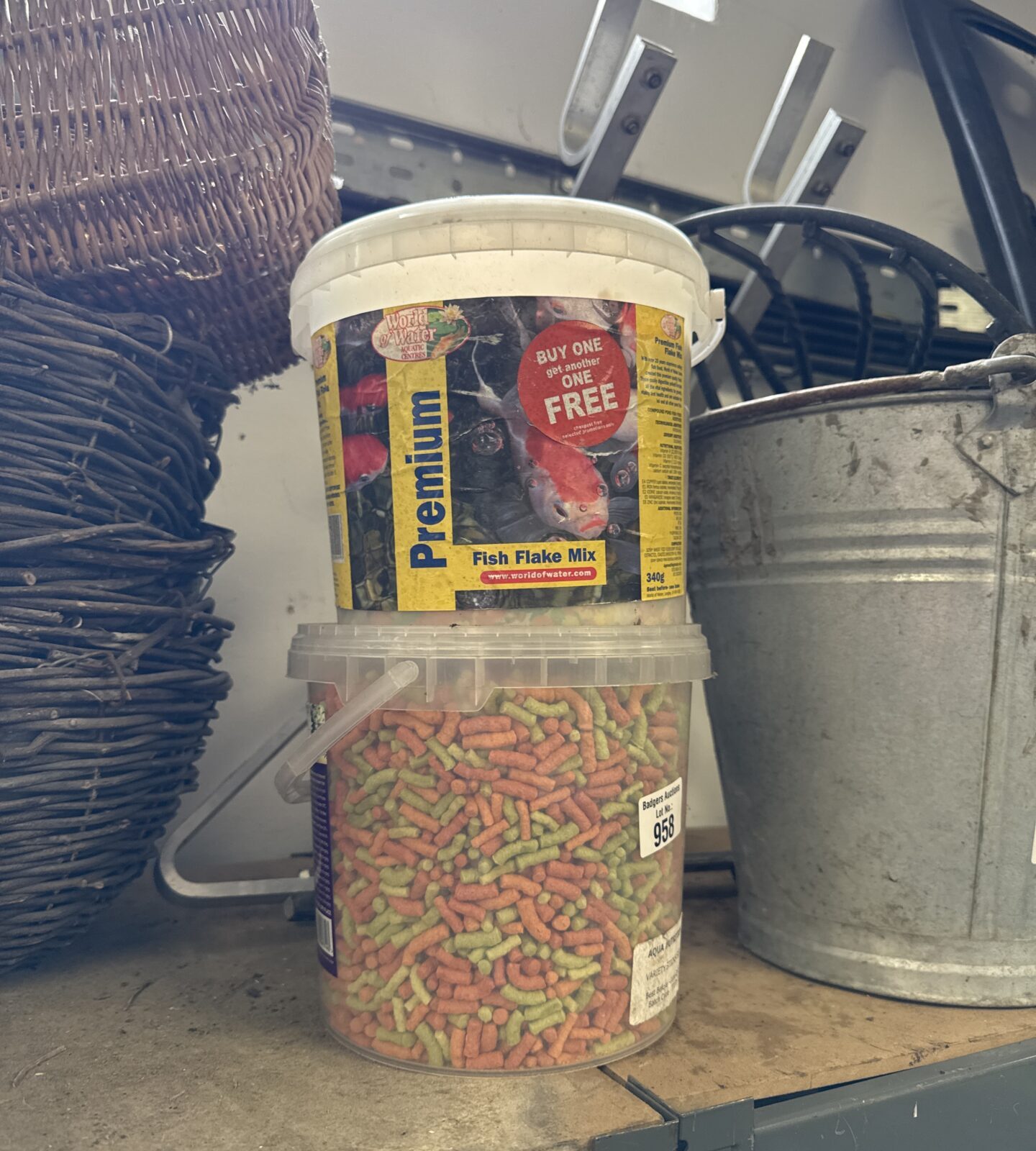 Two tubs of pond fish food