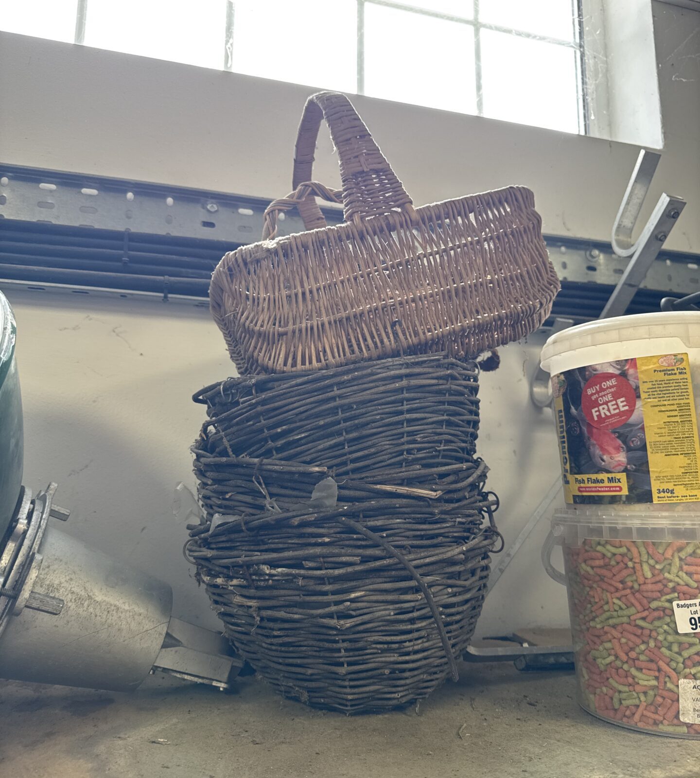 Three woven hanging baskets with wicker hand basket
