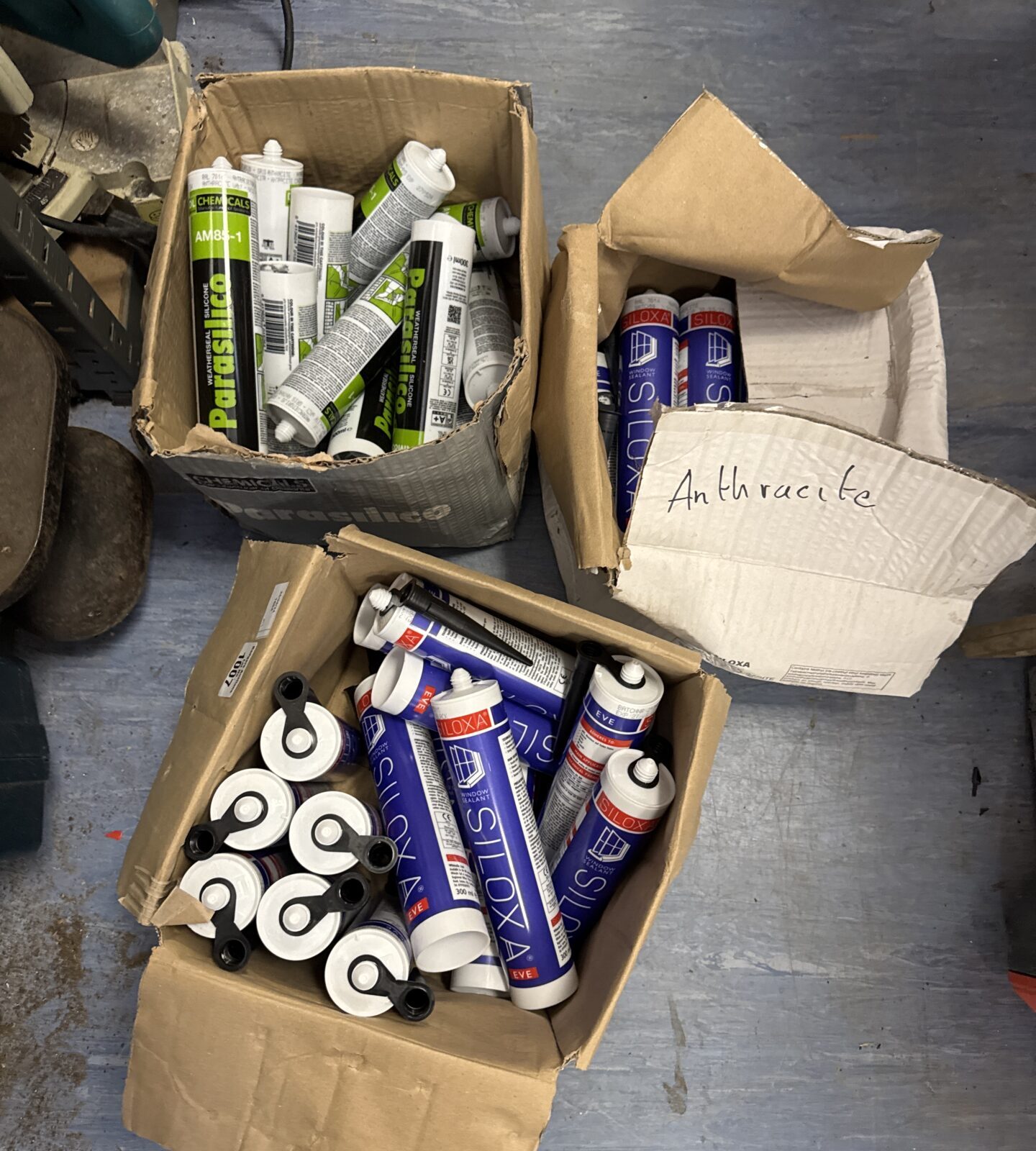 Three boxes of new tubes of silicone
