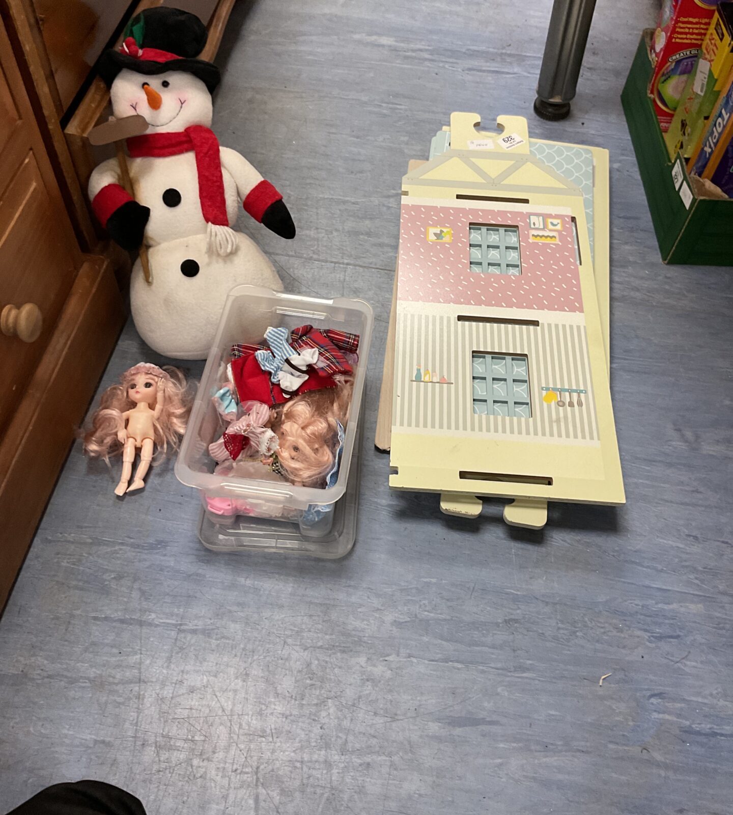 Wooden dolls house with box of dolls