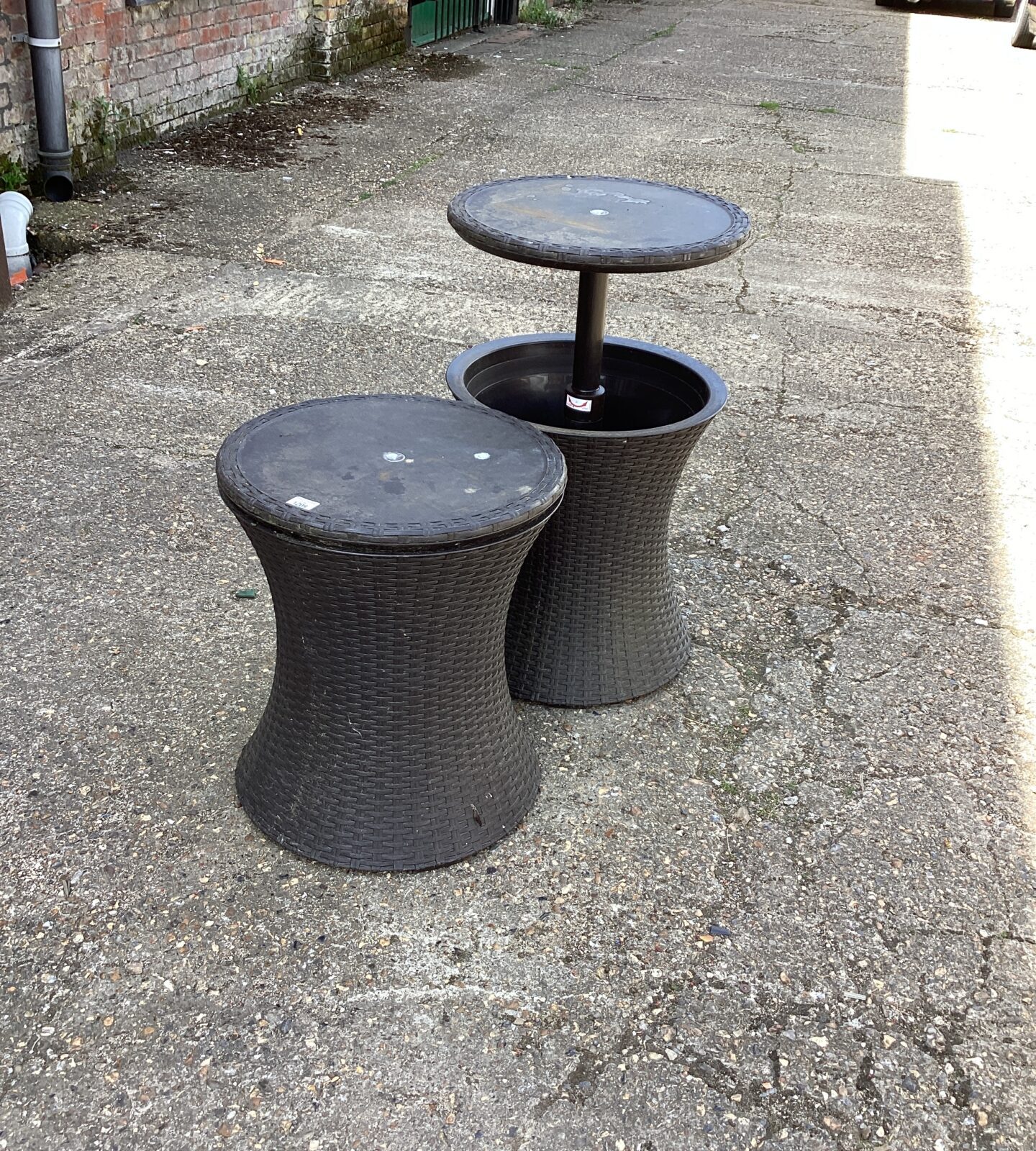 Two plastic drink cooling adjustable tables
