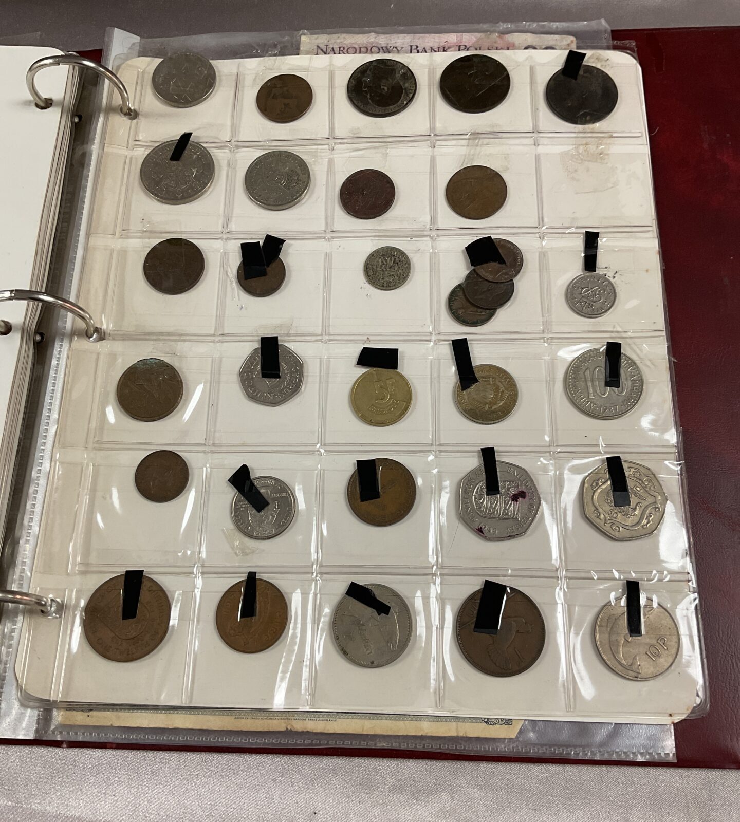 Coin album with assorted coins and bank notes