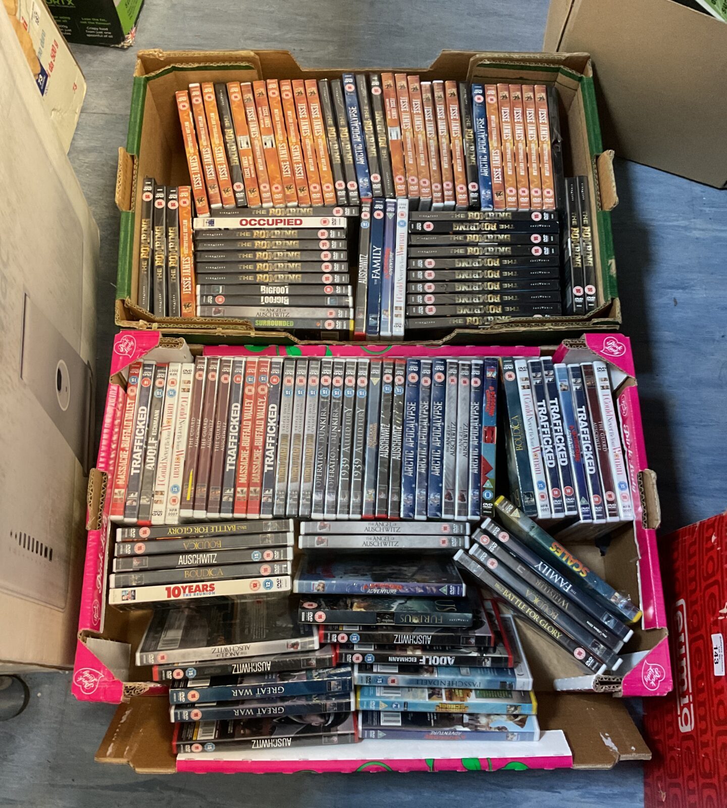 Two trays of new & sealed dvds including the bombing & jesse james