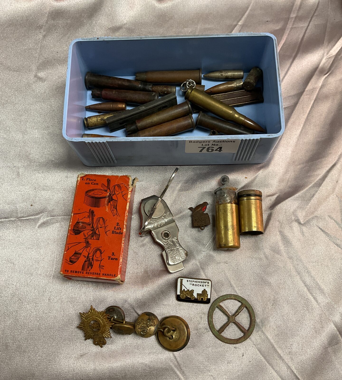 Tub of spent bullets tin opener badges and trench art lighter