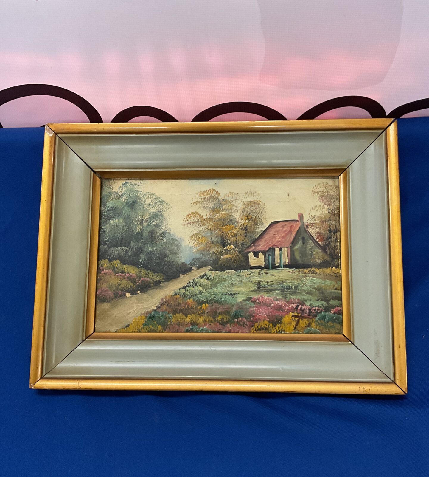 Gilt framed oil painting of a country cottage