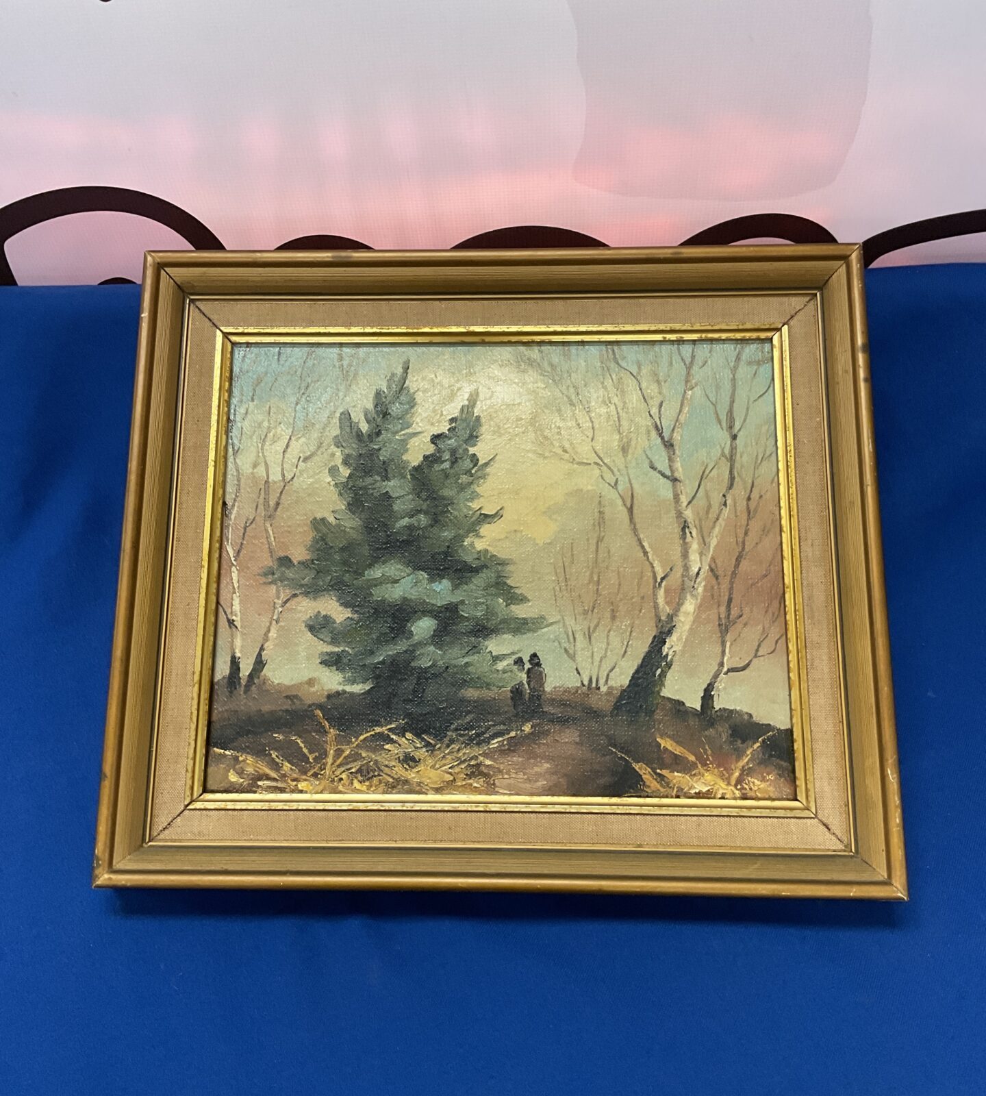 Gilt framed oil painting of a woodland scene with figure