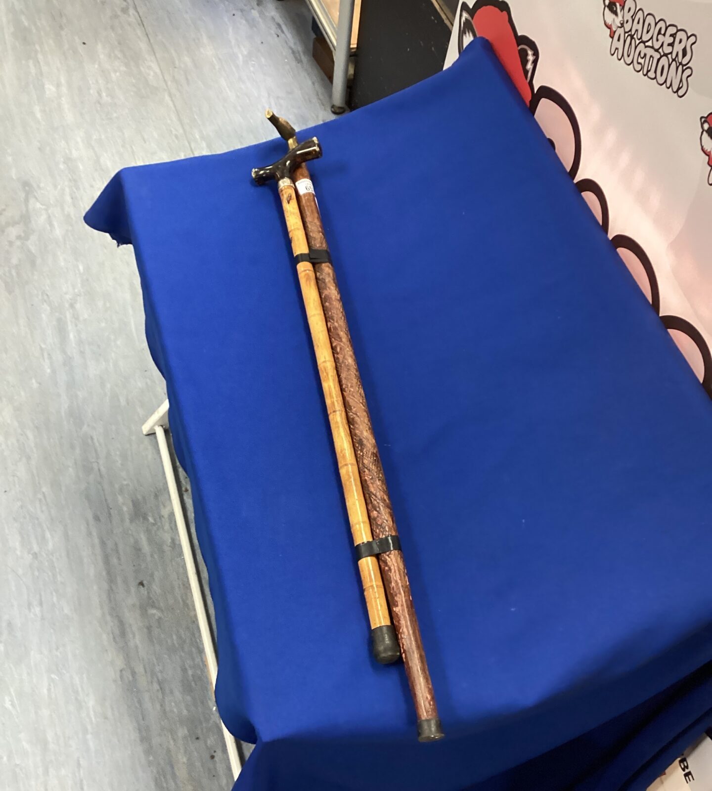 Two walking sticks one with brass horse head