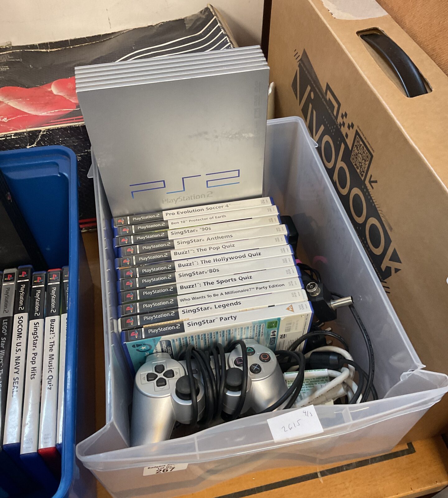 Silver Sony PlayStation 2 console with games
