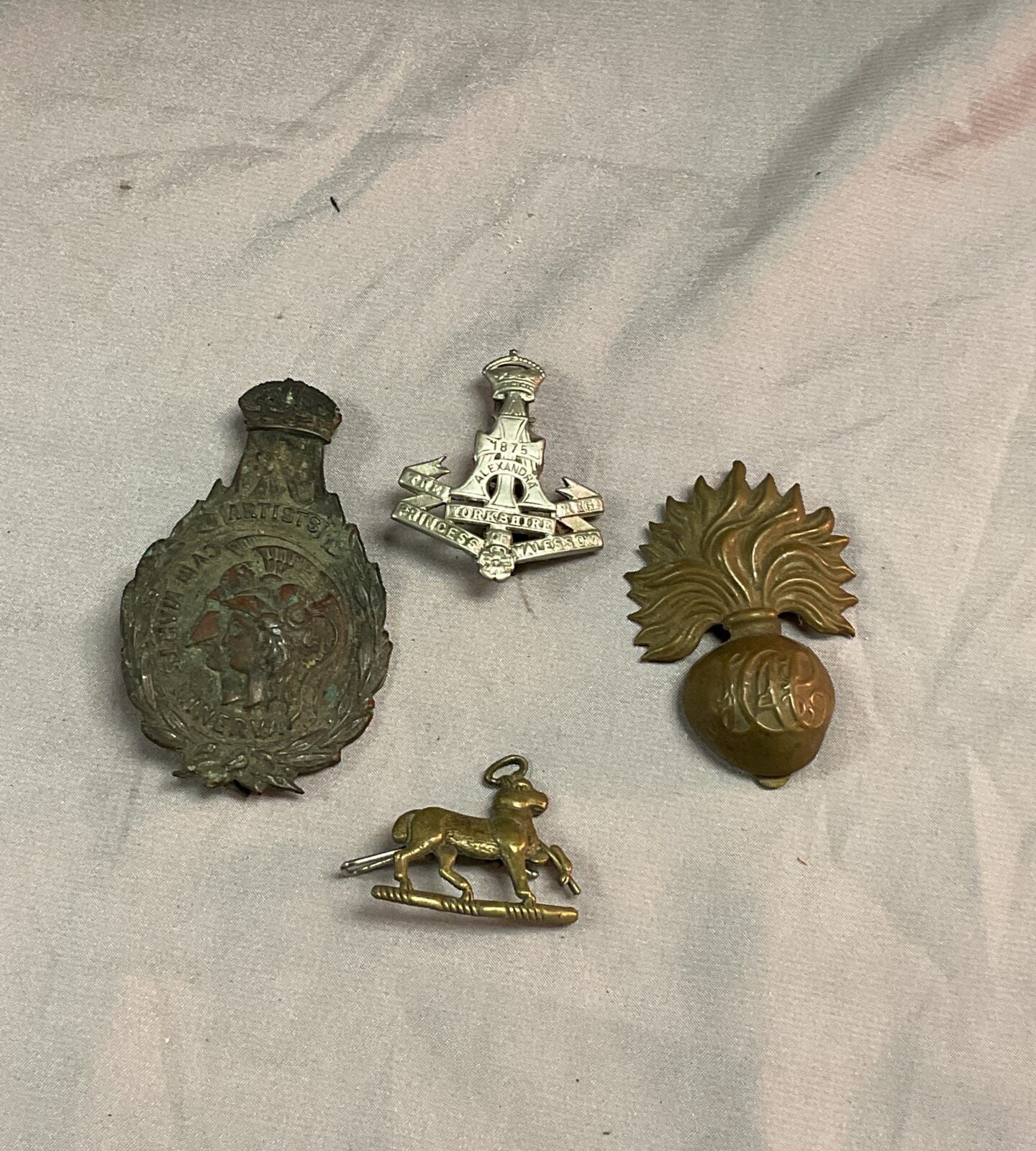 Four vintage military badges