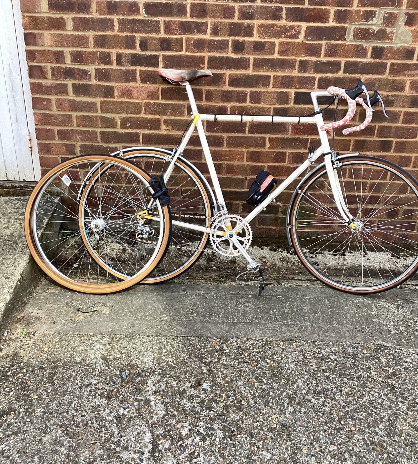 White Racing Bike with spare tyres
