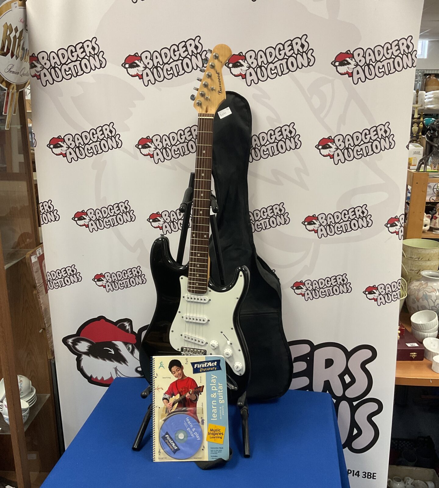 Burswood electric guitar with case, learning guitar book & stand