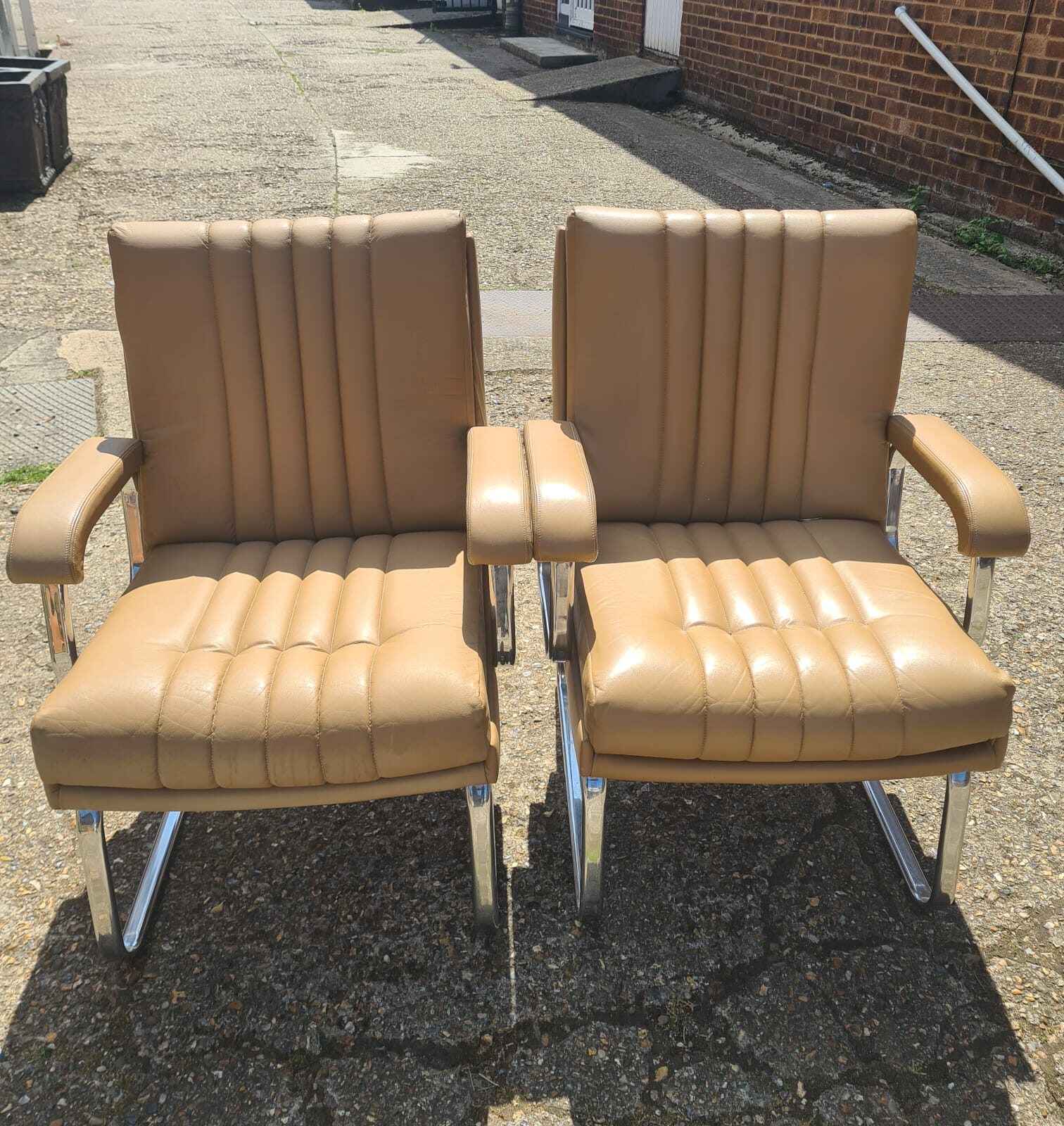 Two Verco 1970s chrome and tan leather office chairs