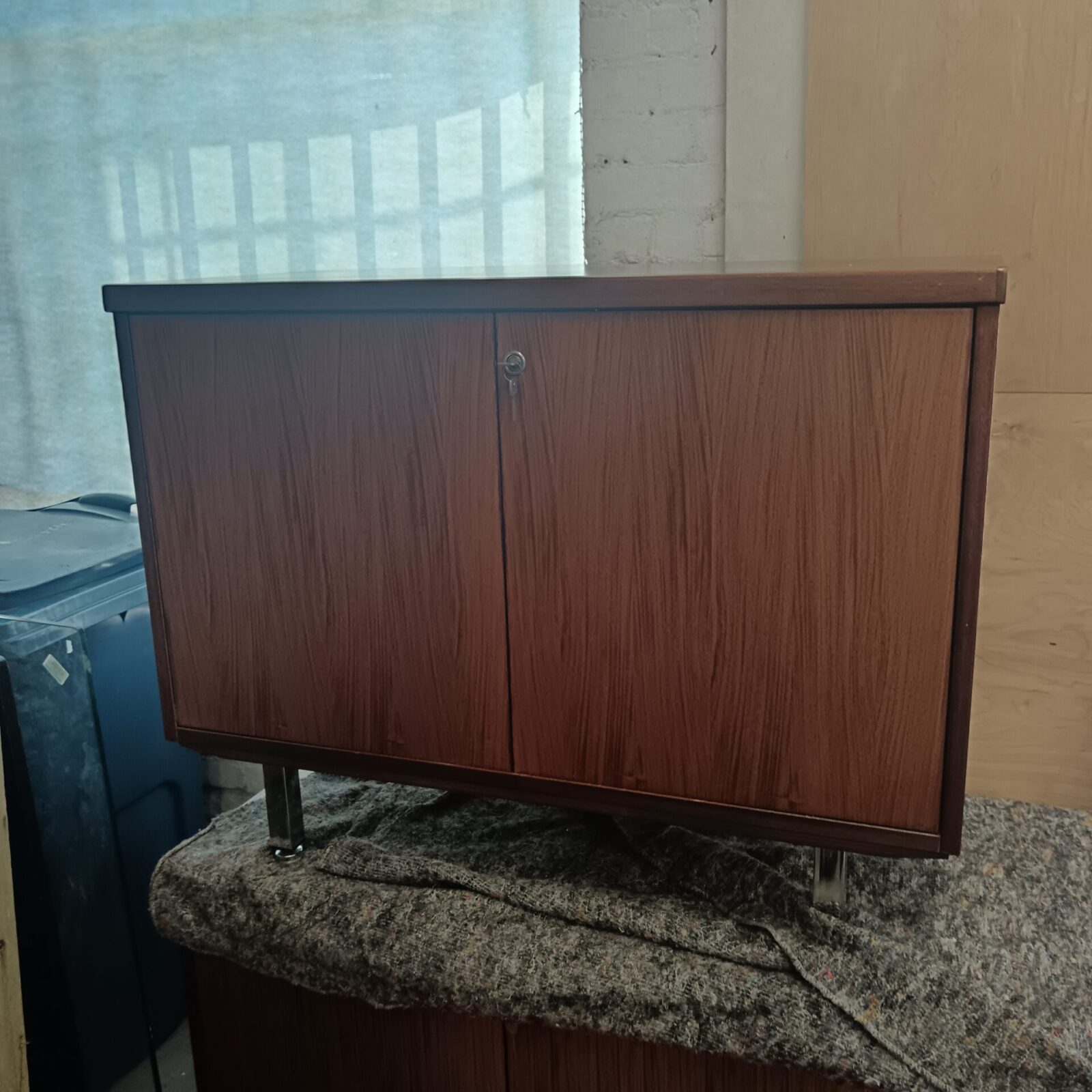 Vintage chrome legged storage cabinet with keys
