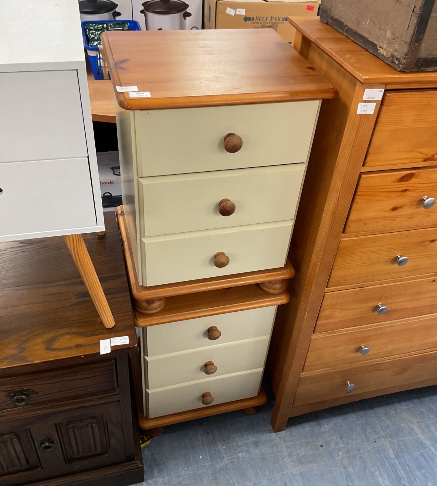 Two cream and pine beside set of draws