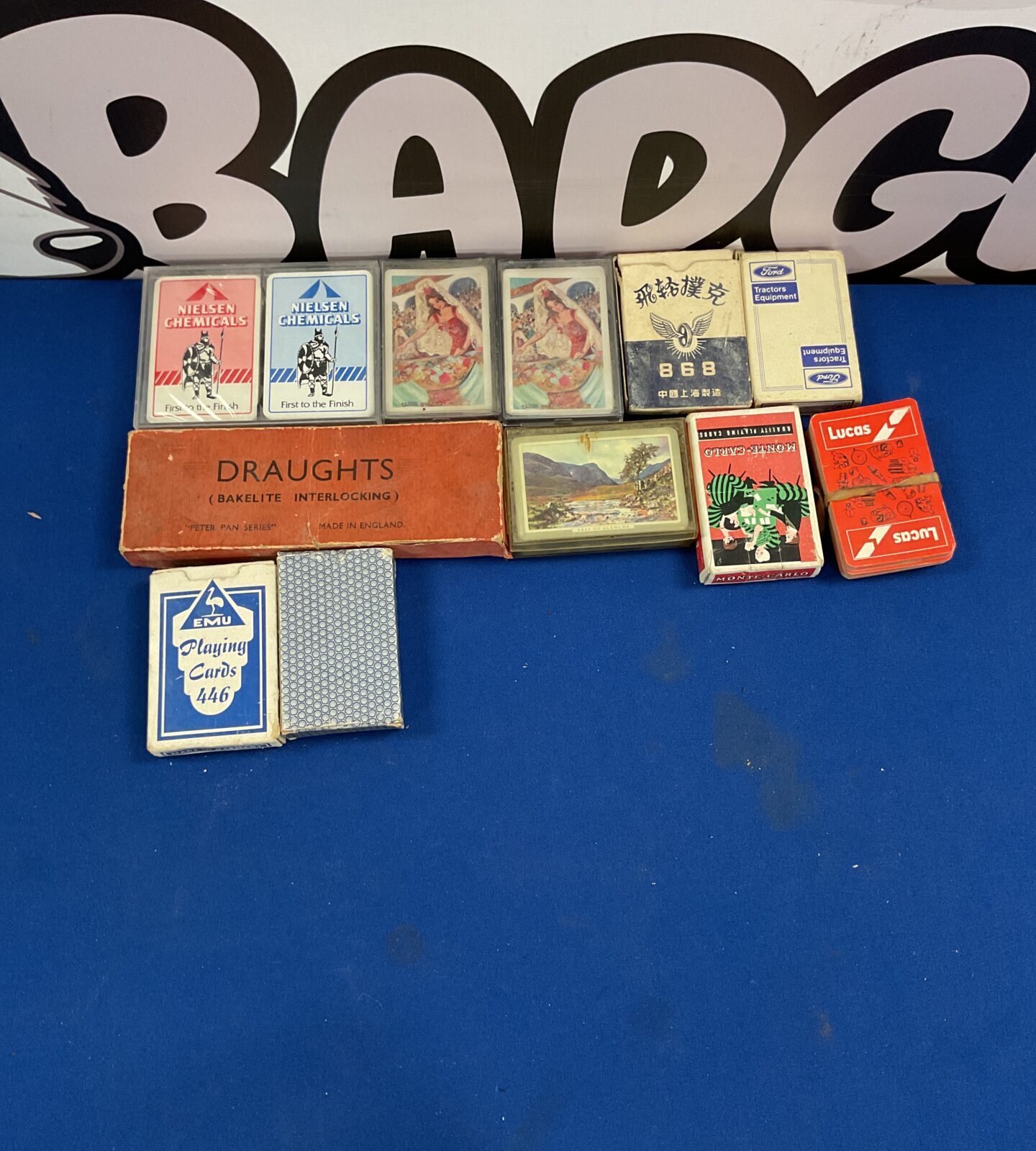 Box of vintage playing cards and draught set