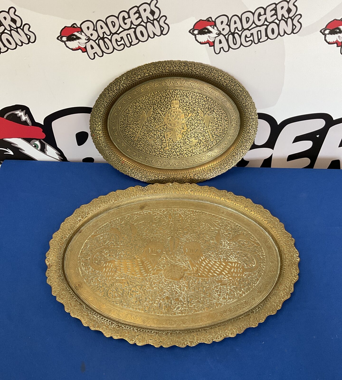 Two brass chinese trays one with lion design