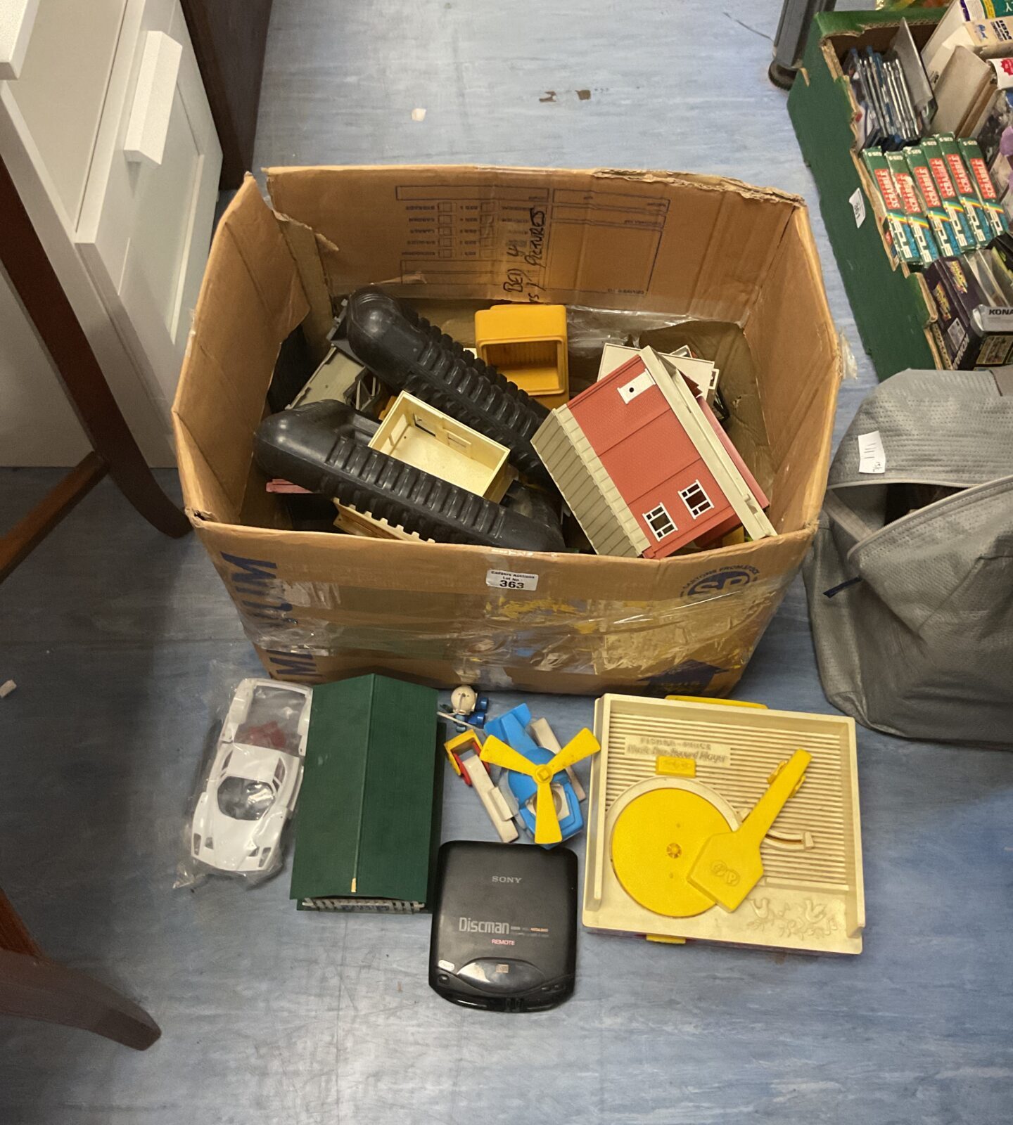 Box of mixed vintage and retro items inc somy discman, scalextric buildings and vintage fisher price music box and record player