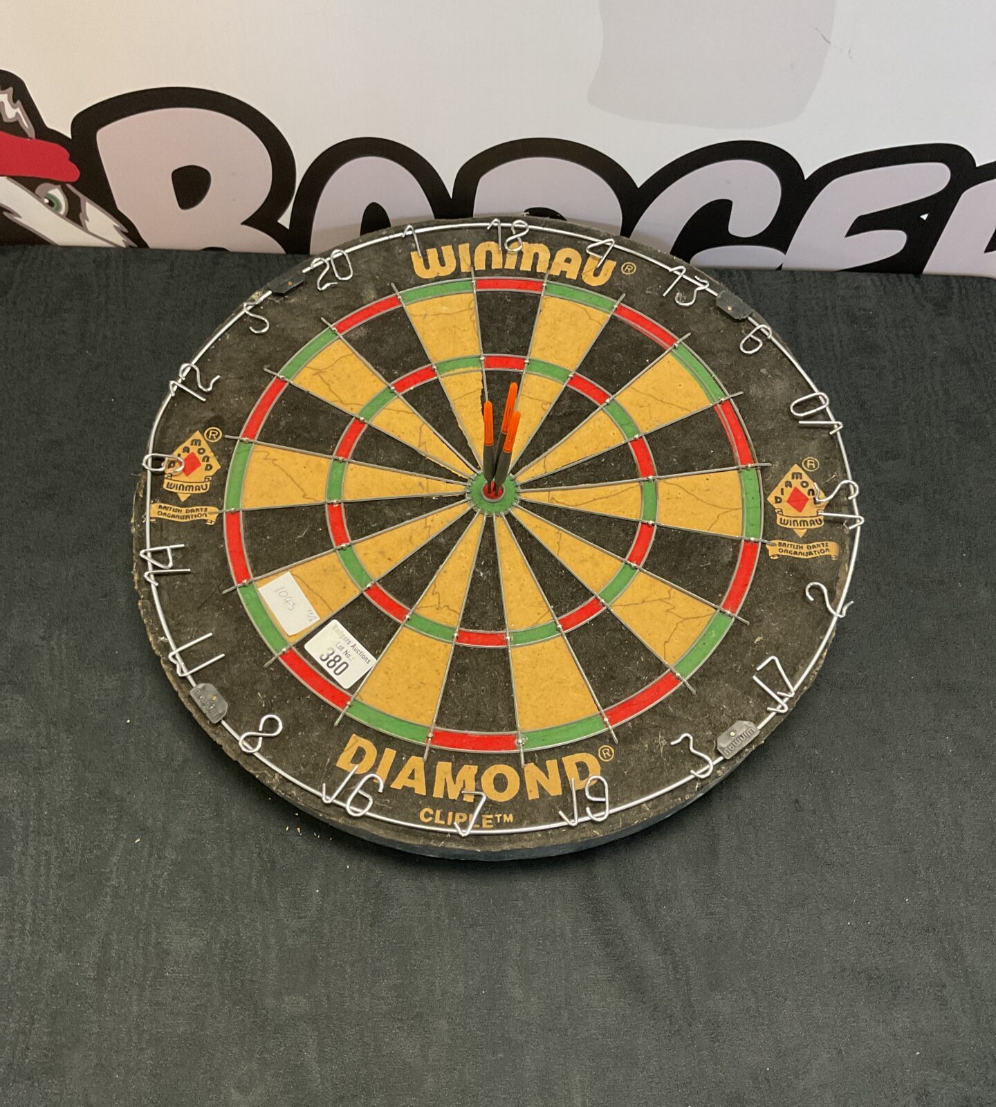 Winmau dartboard with darts