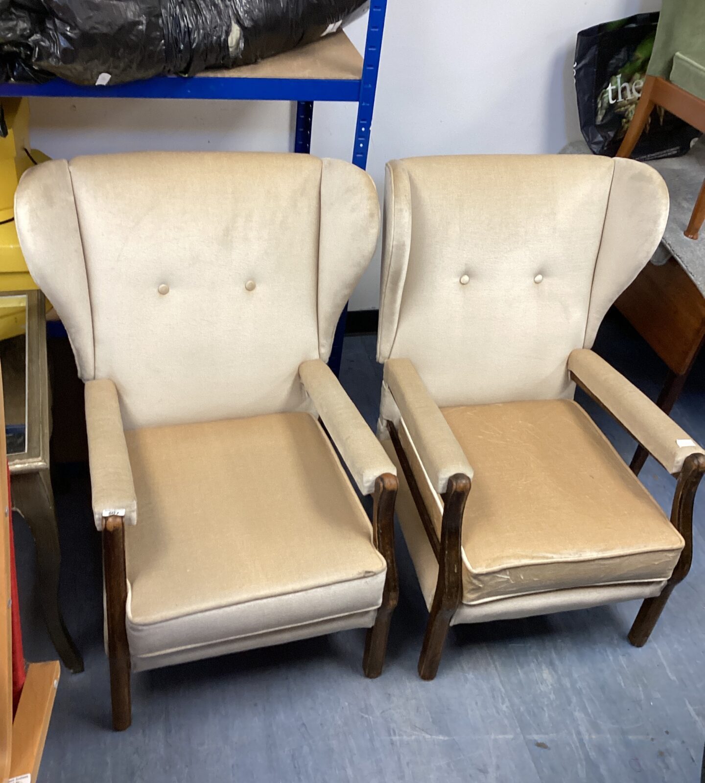 Two vintage cream wingback chairs