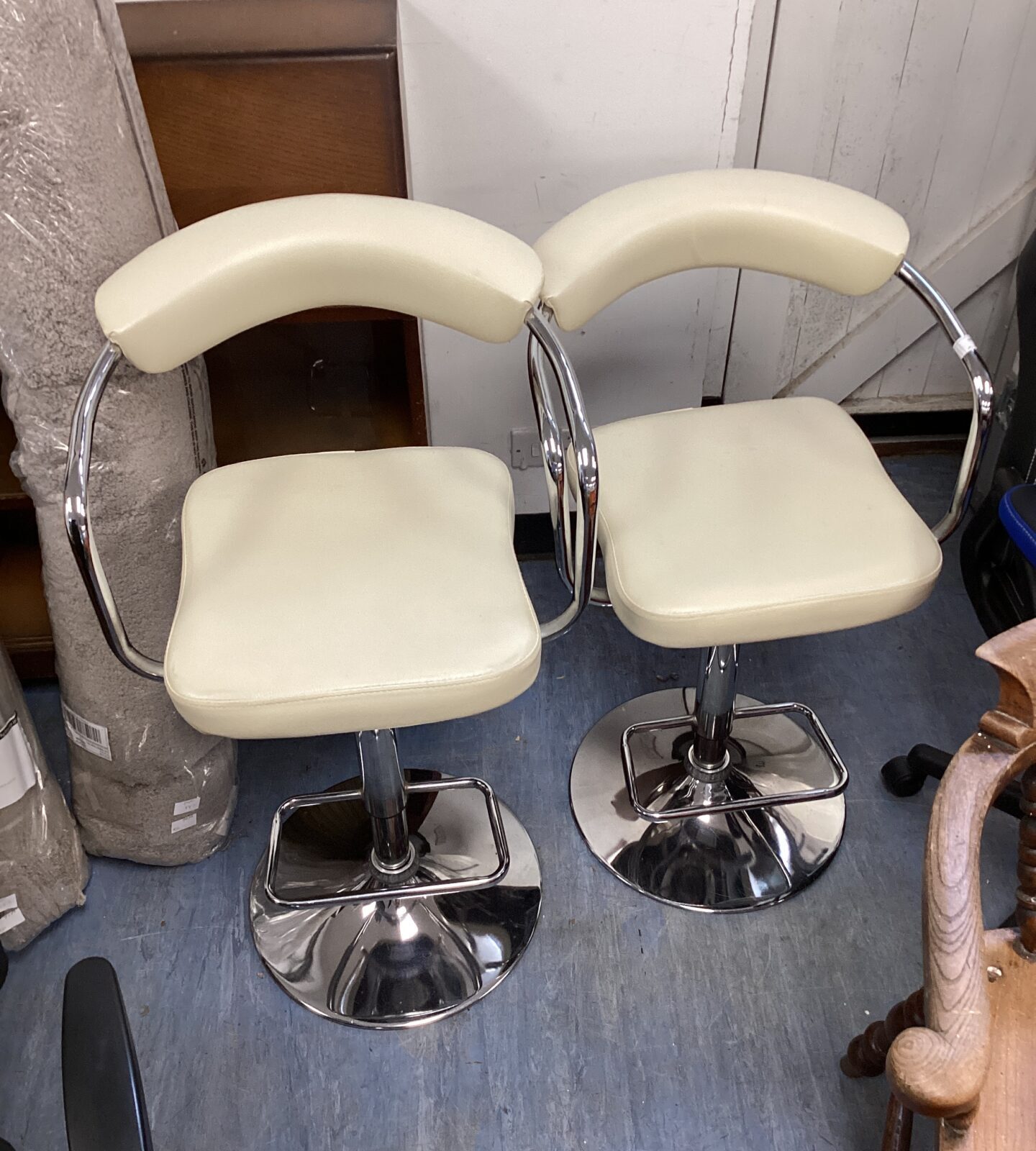 Two cream leather bar stools