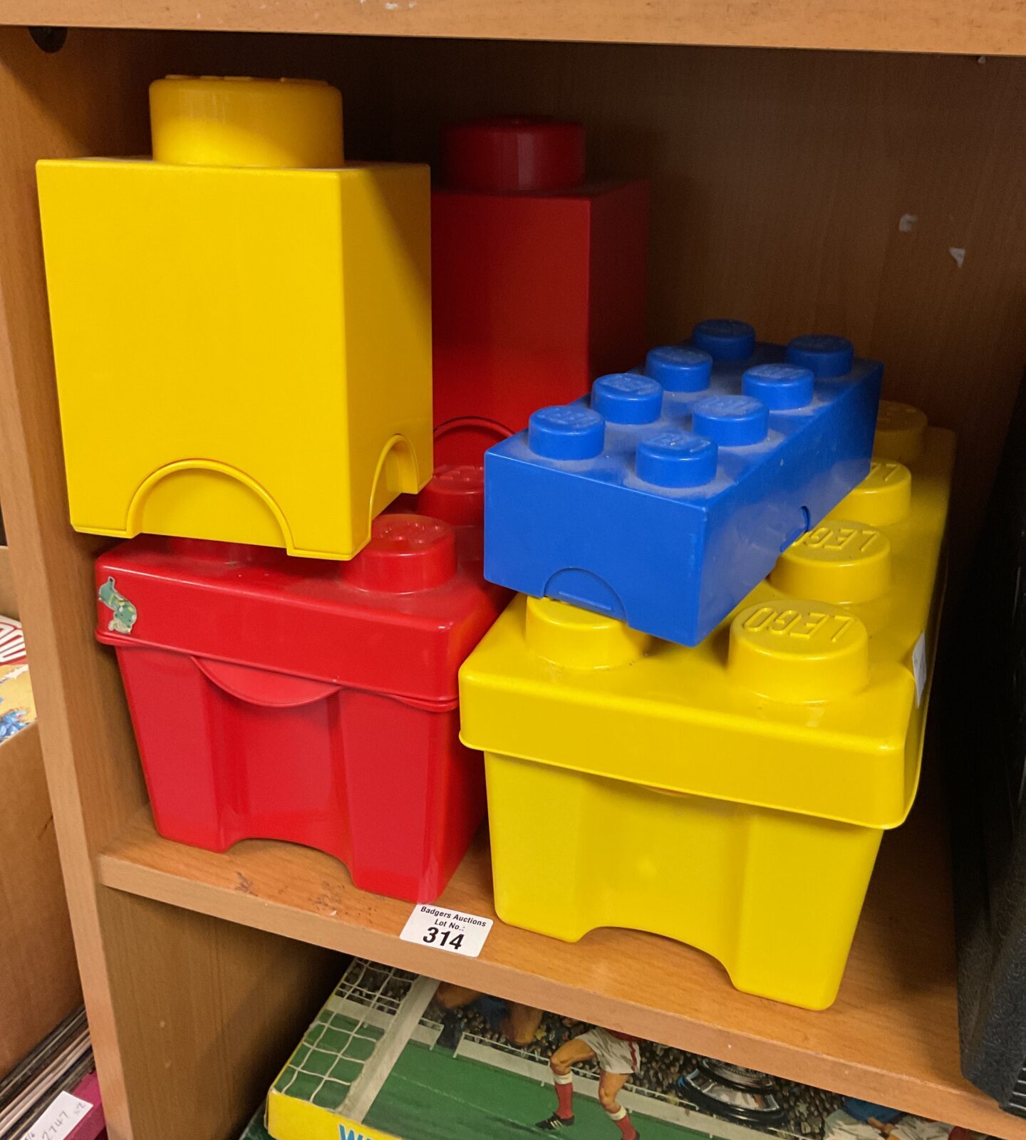 Four empty Lego storage boxes