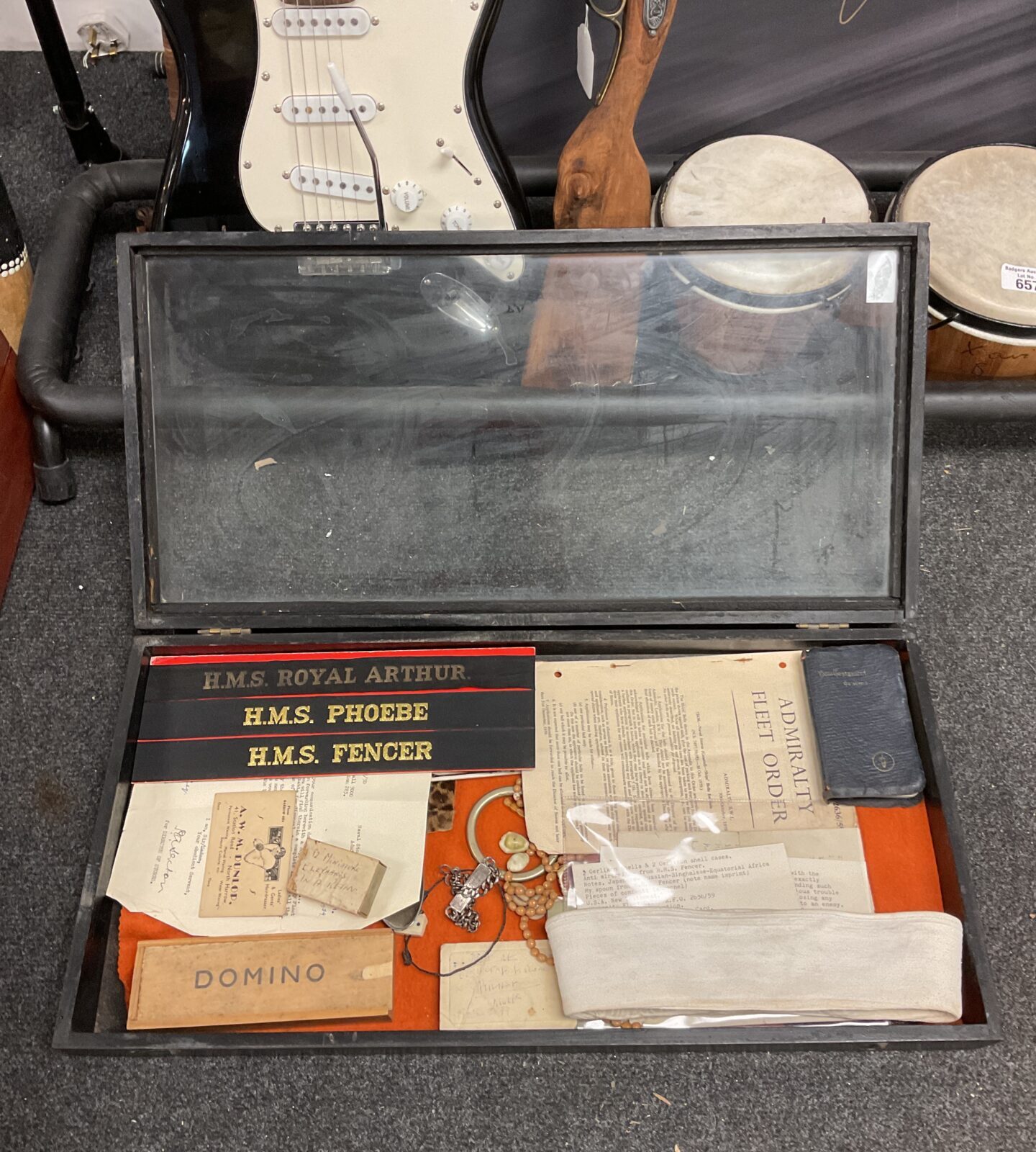 Display case with contents including pork pie us navy hat & militaria