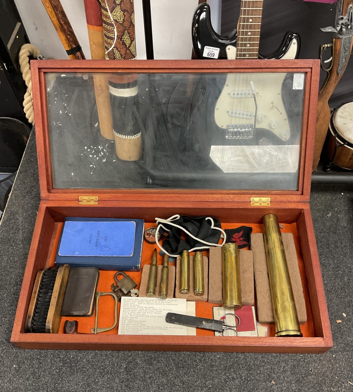 Display case with contents including canon shells & militaria