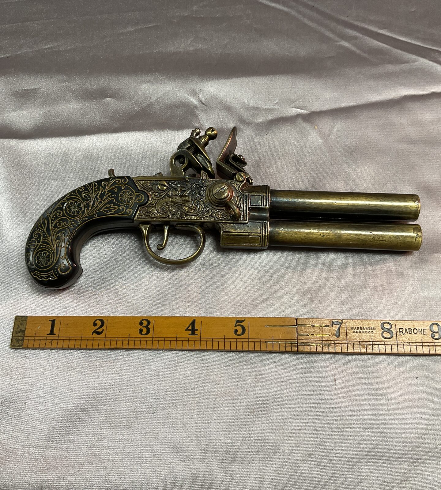 Reproduction brass double barrel flintlock pistol