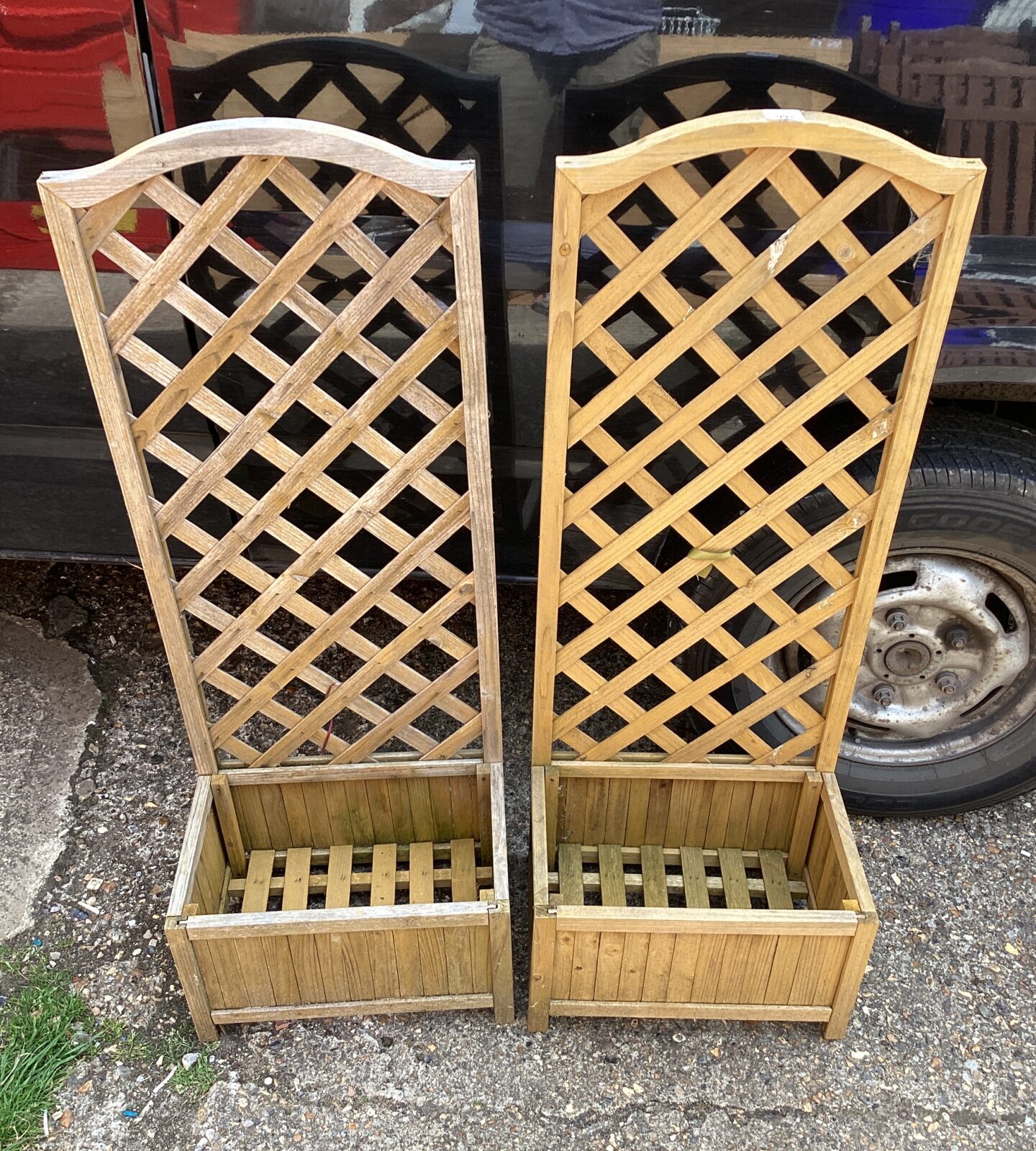 Two wooden garden planters with vine support