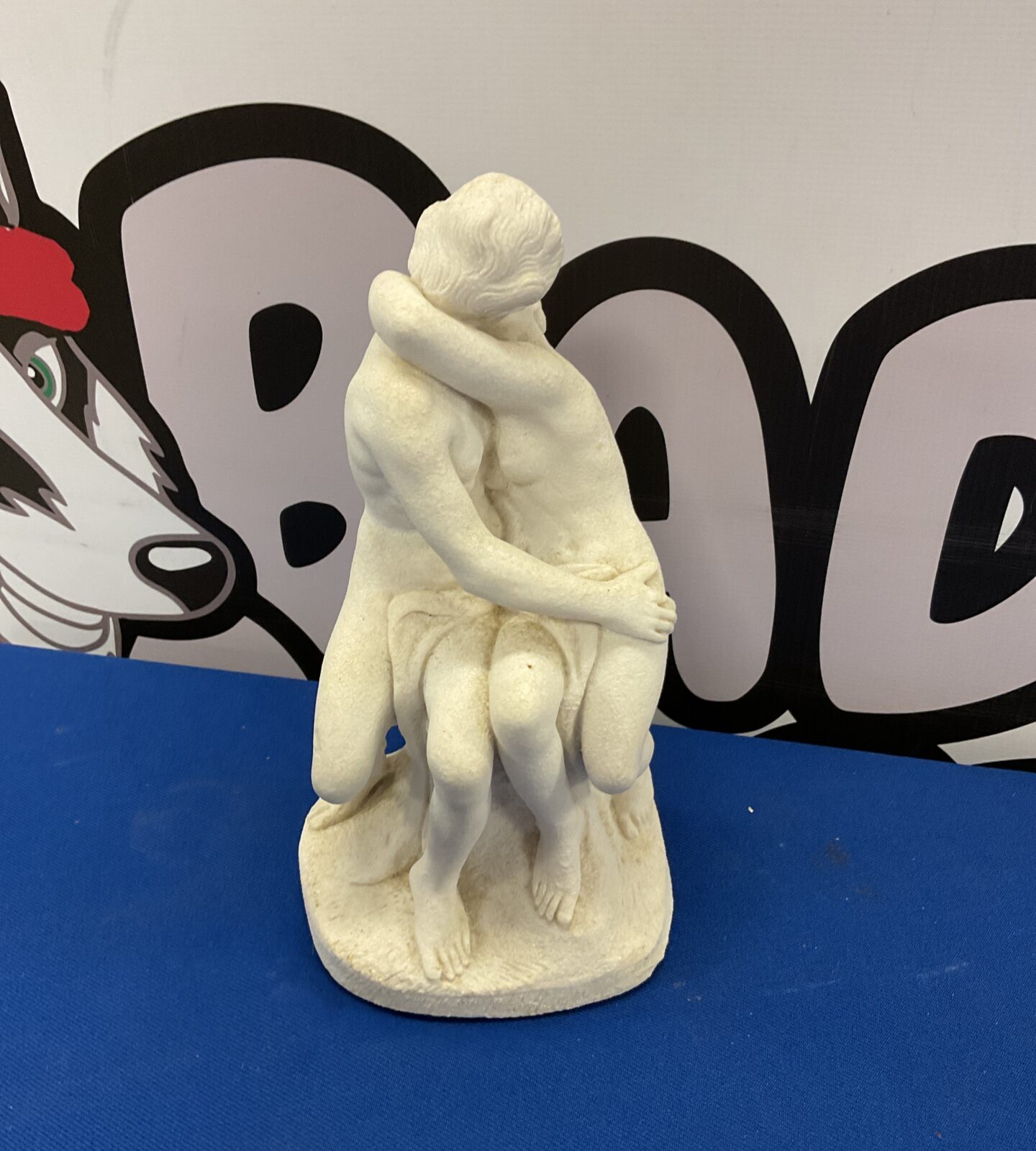 Porcelain sculpture of lovers embracing
