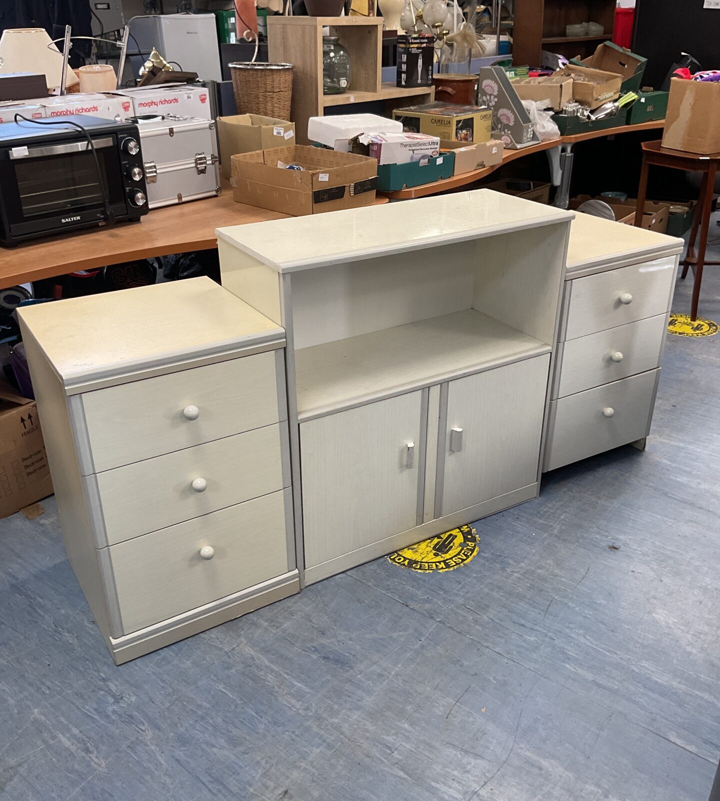 Two white three draw bedside cabinets and white side cabinet