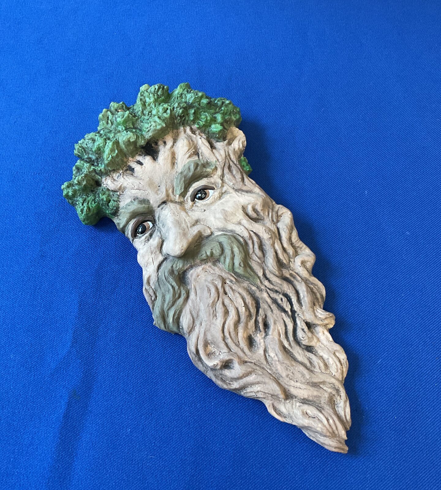 Reconstituted stone green man head wall plaque
