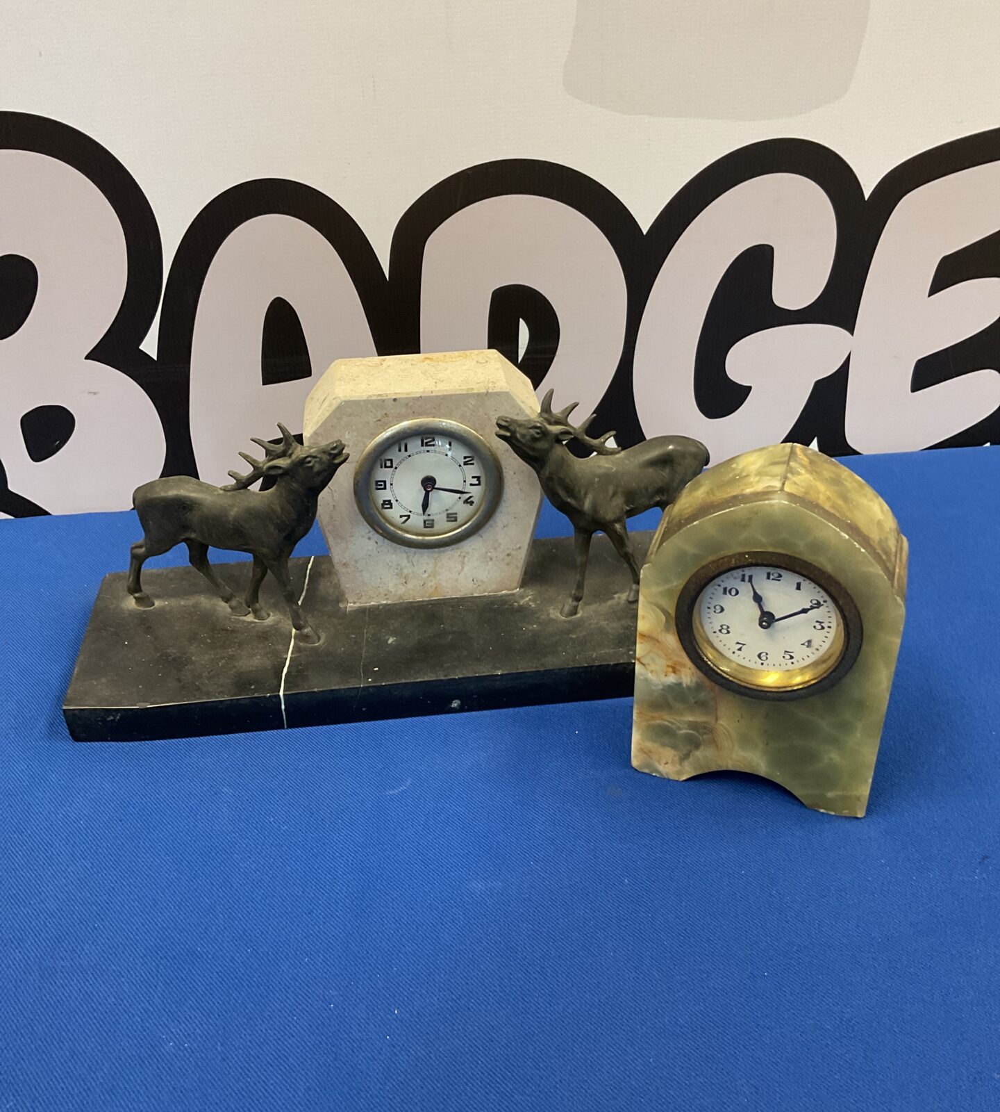 Two vintage stone clocks including stag clock