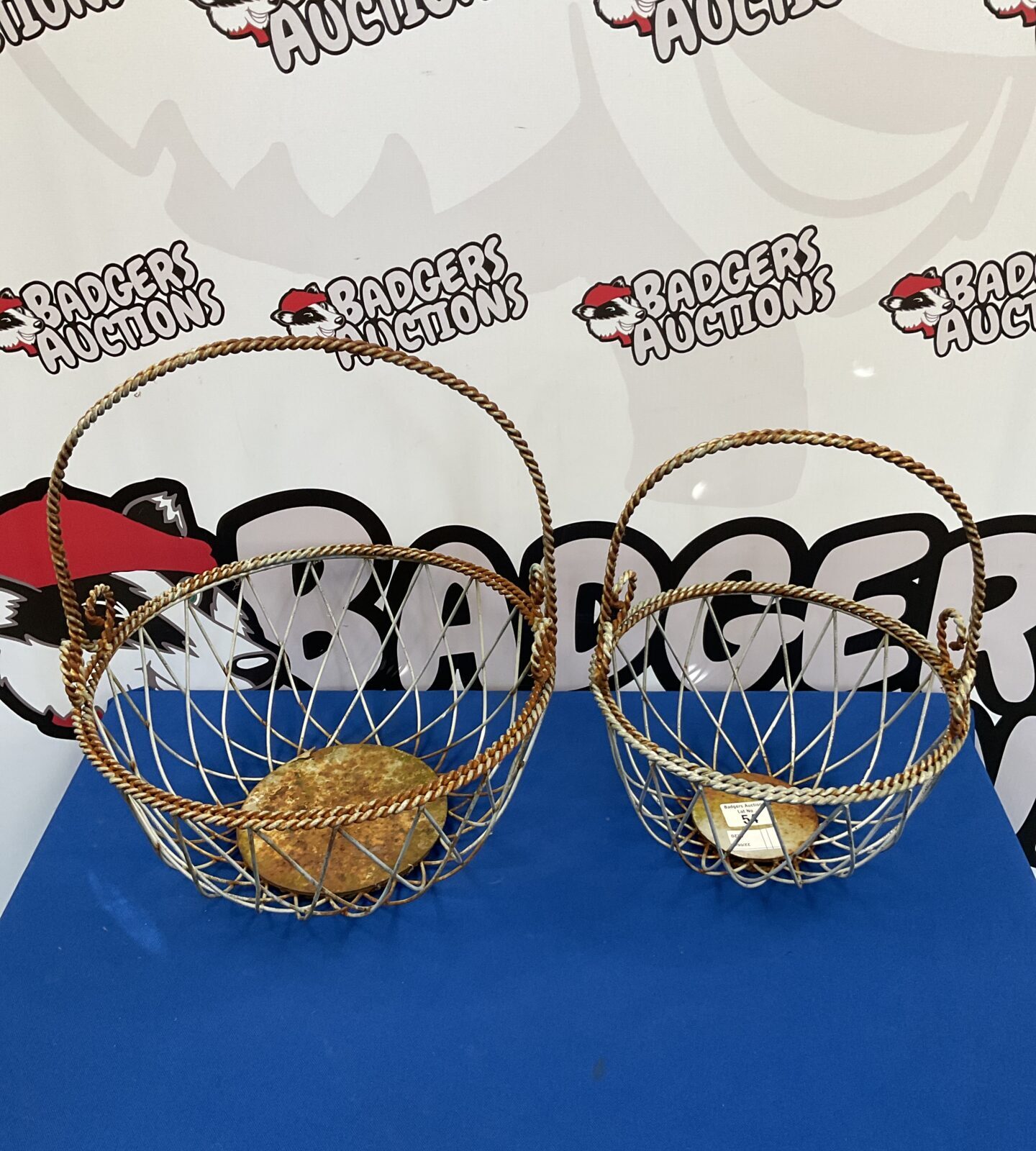 Two ornate metal hanging baskets