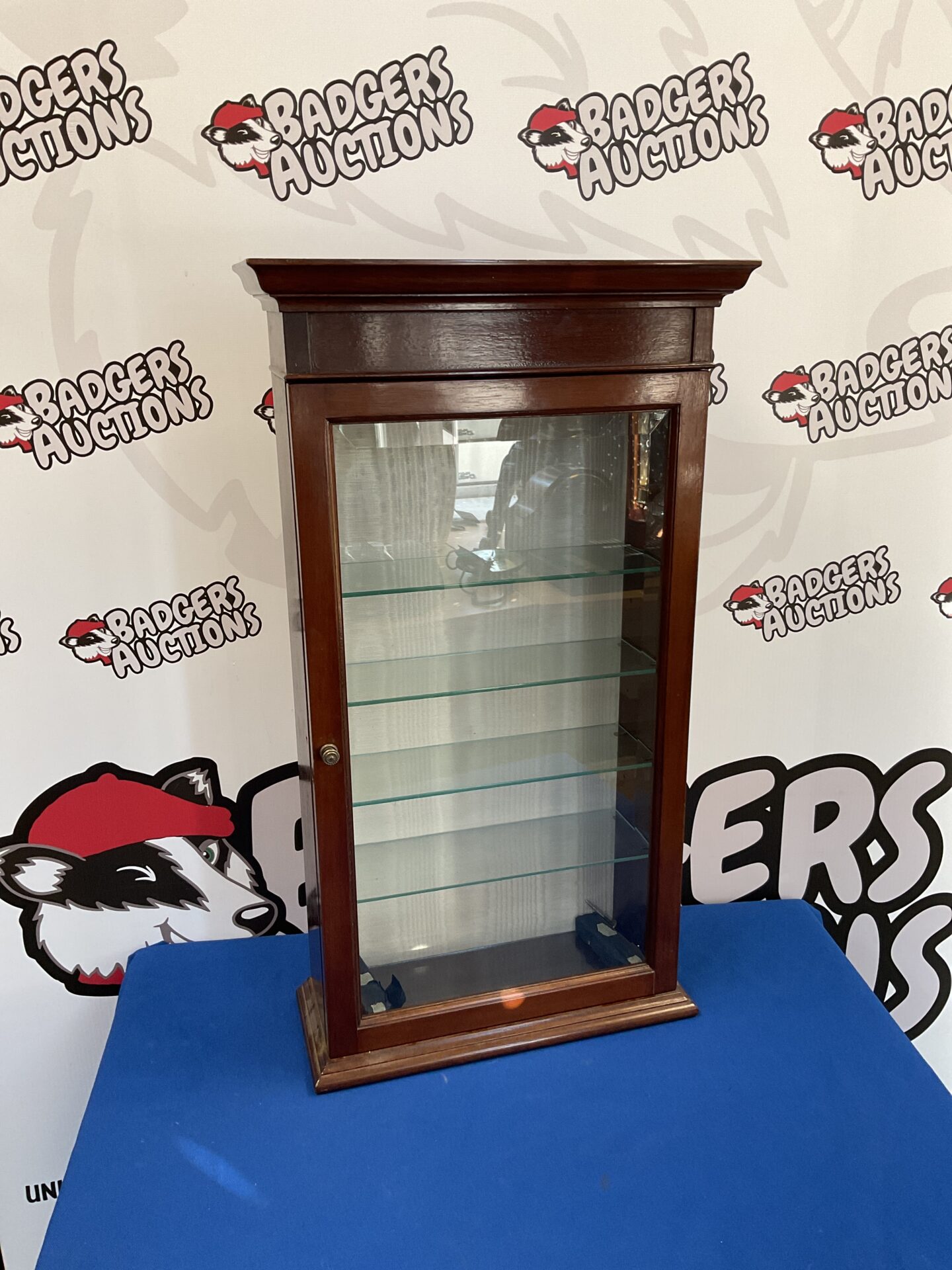 Small mahogany display cabinet with glass shelves