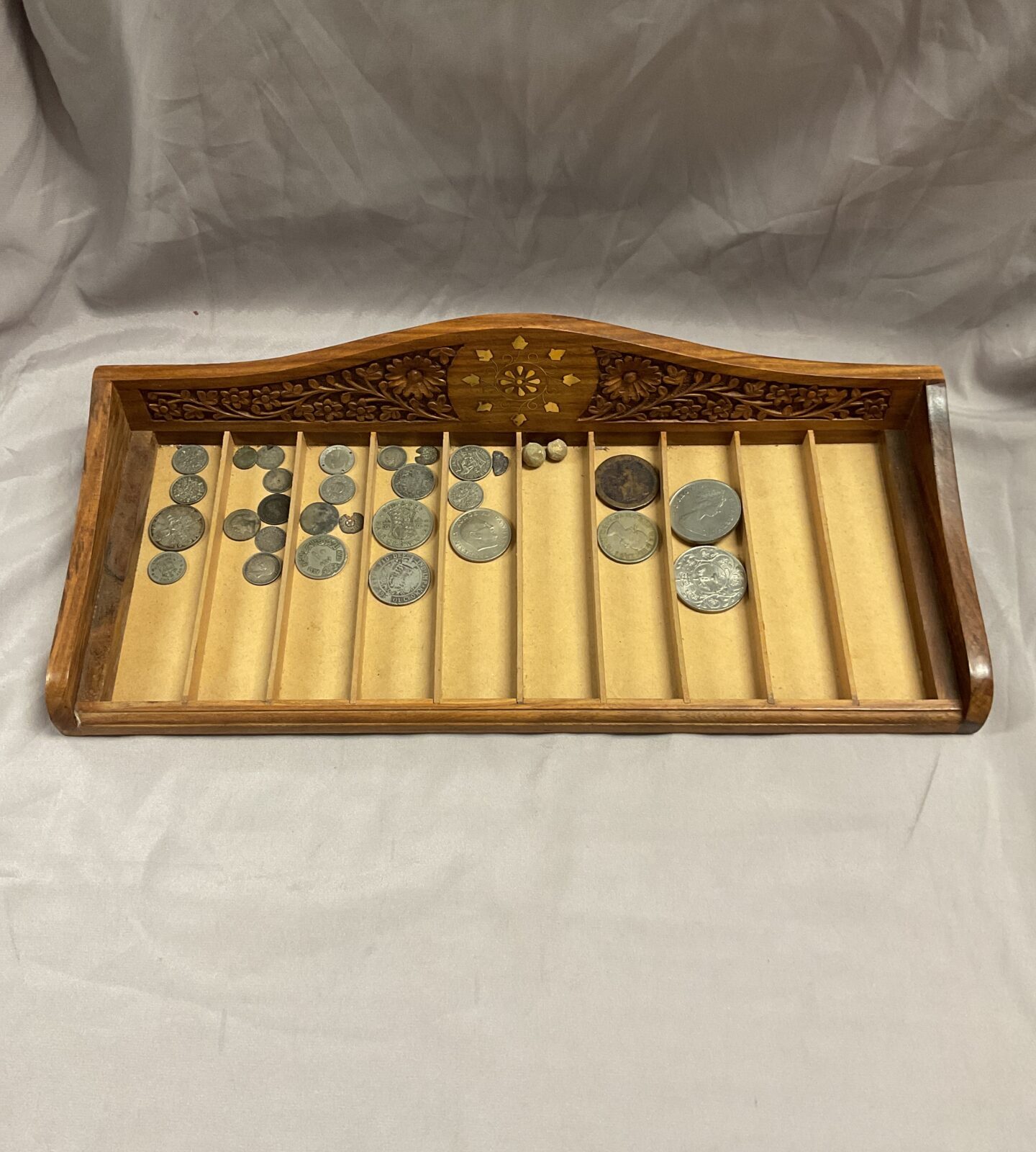 Wood pen tray with assorted coins