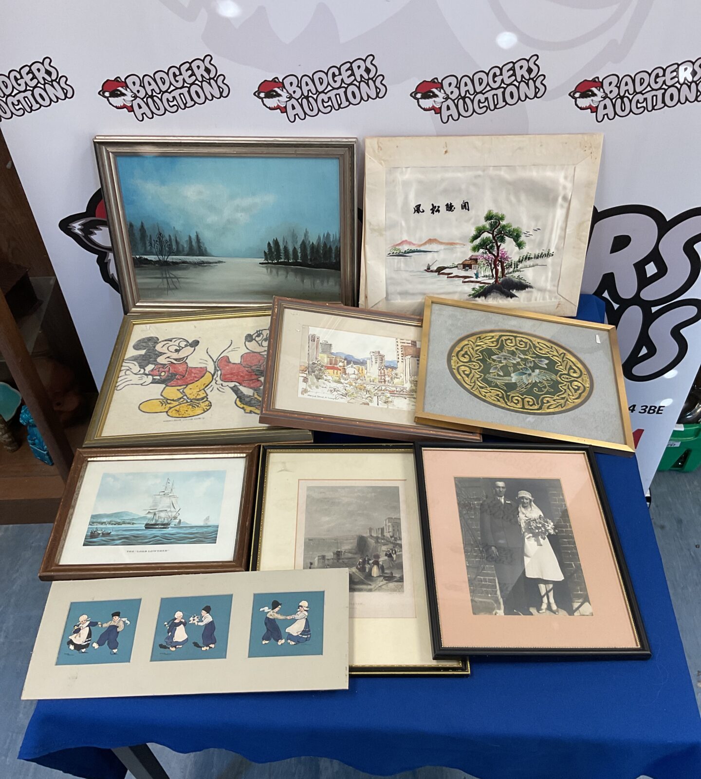 Box of framed prints & artworks including disney mickey & minnie fabric print