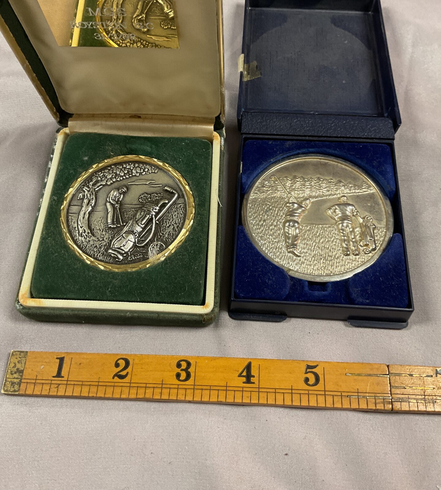 Two unamed golf medals