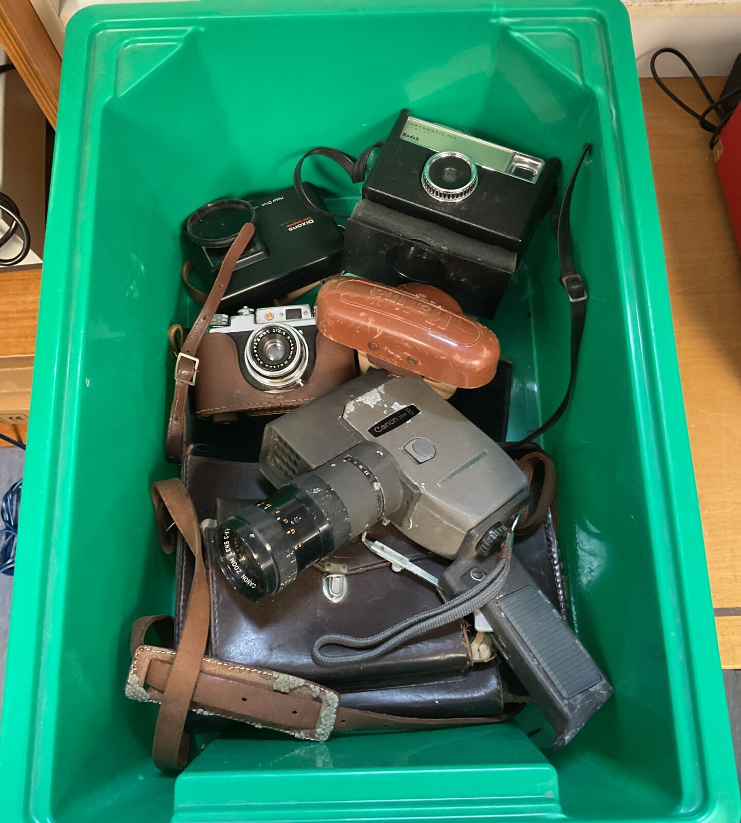 Box of vintage cameras including kodak, halina & canon