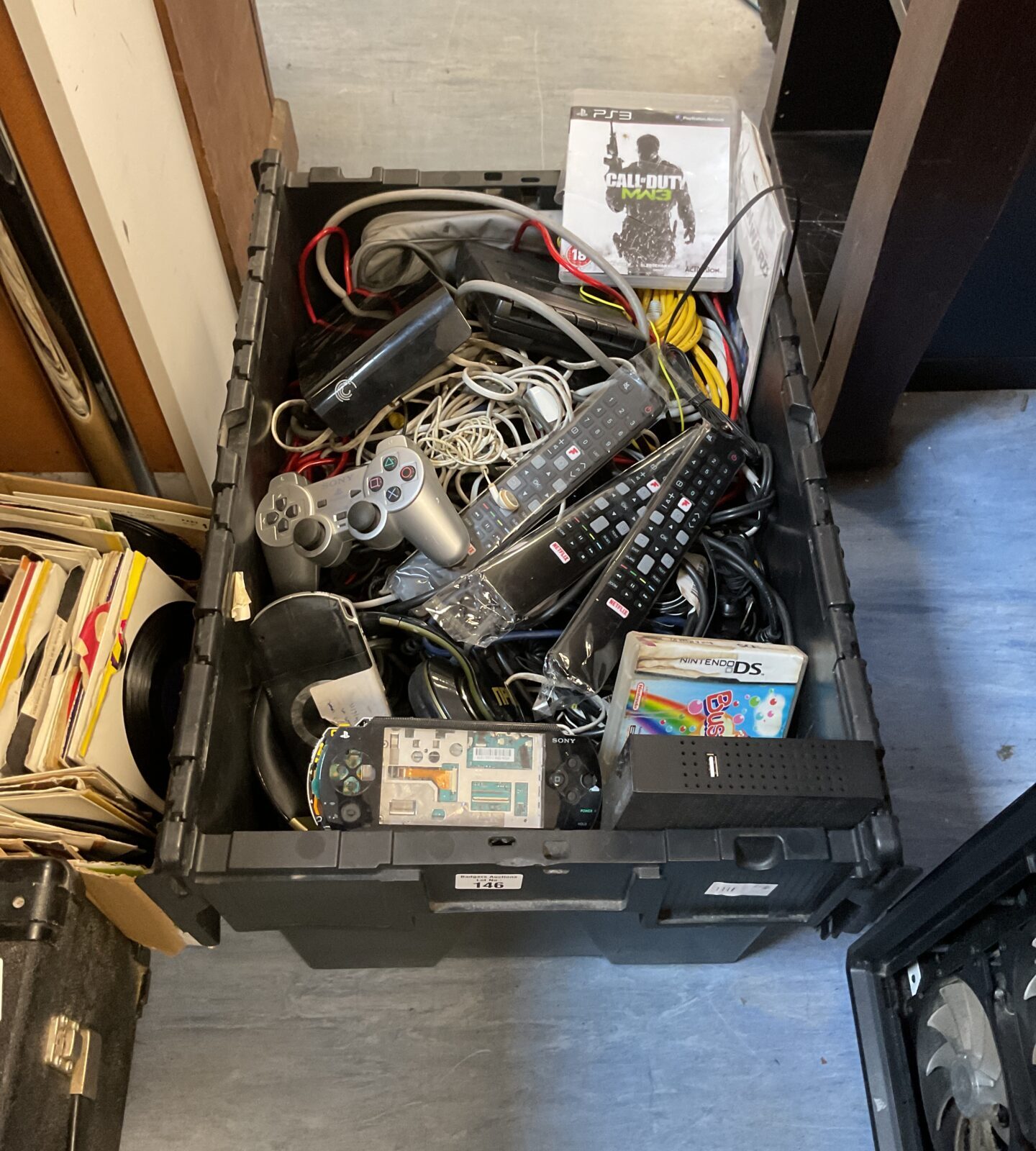 Large crate of mixed electricals inc sony psps for repair, remotes, controllers and other