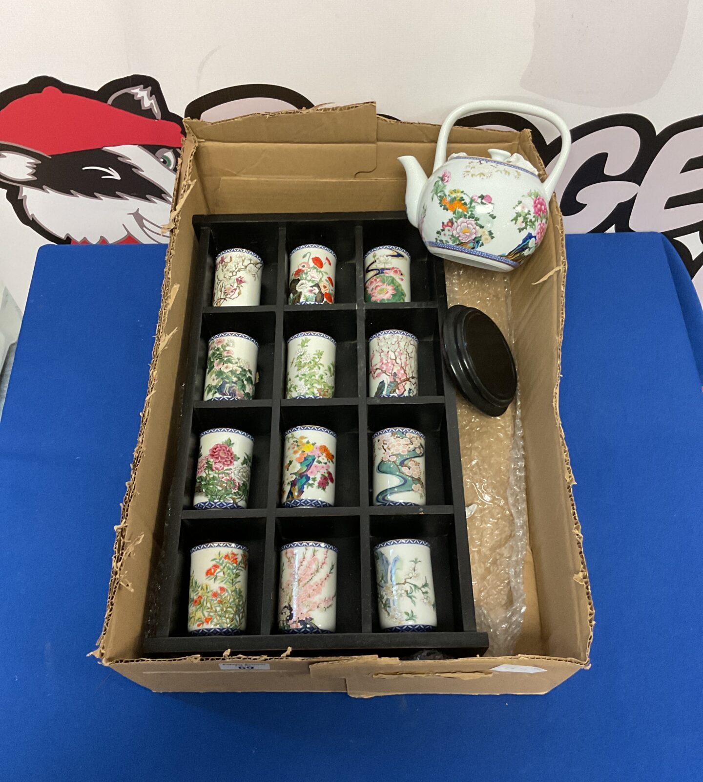 Set of vintage Japanese teacups in display case with teapot
