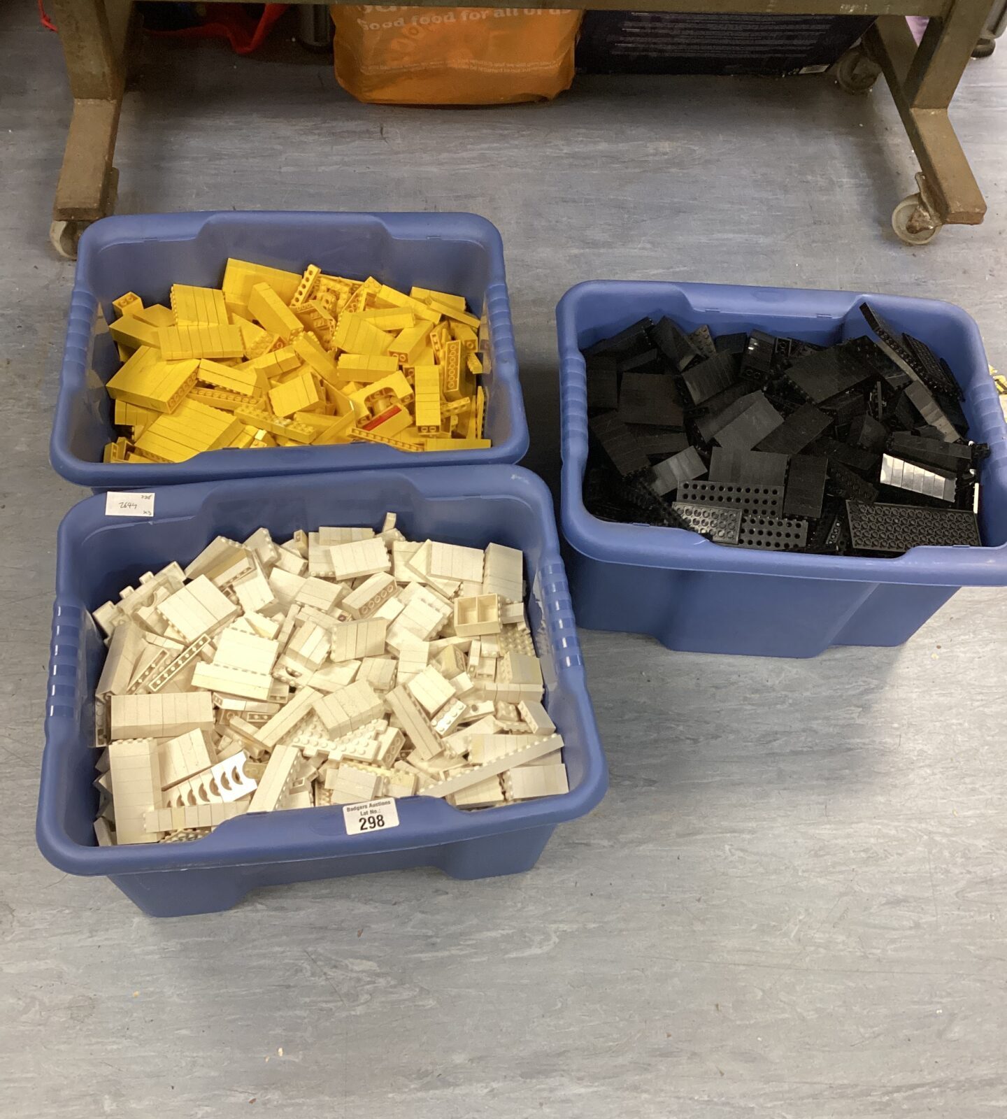 Three boxes of vintage lego sorted into white, yellow & black bricks