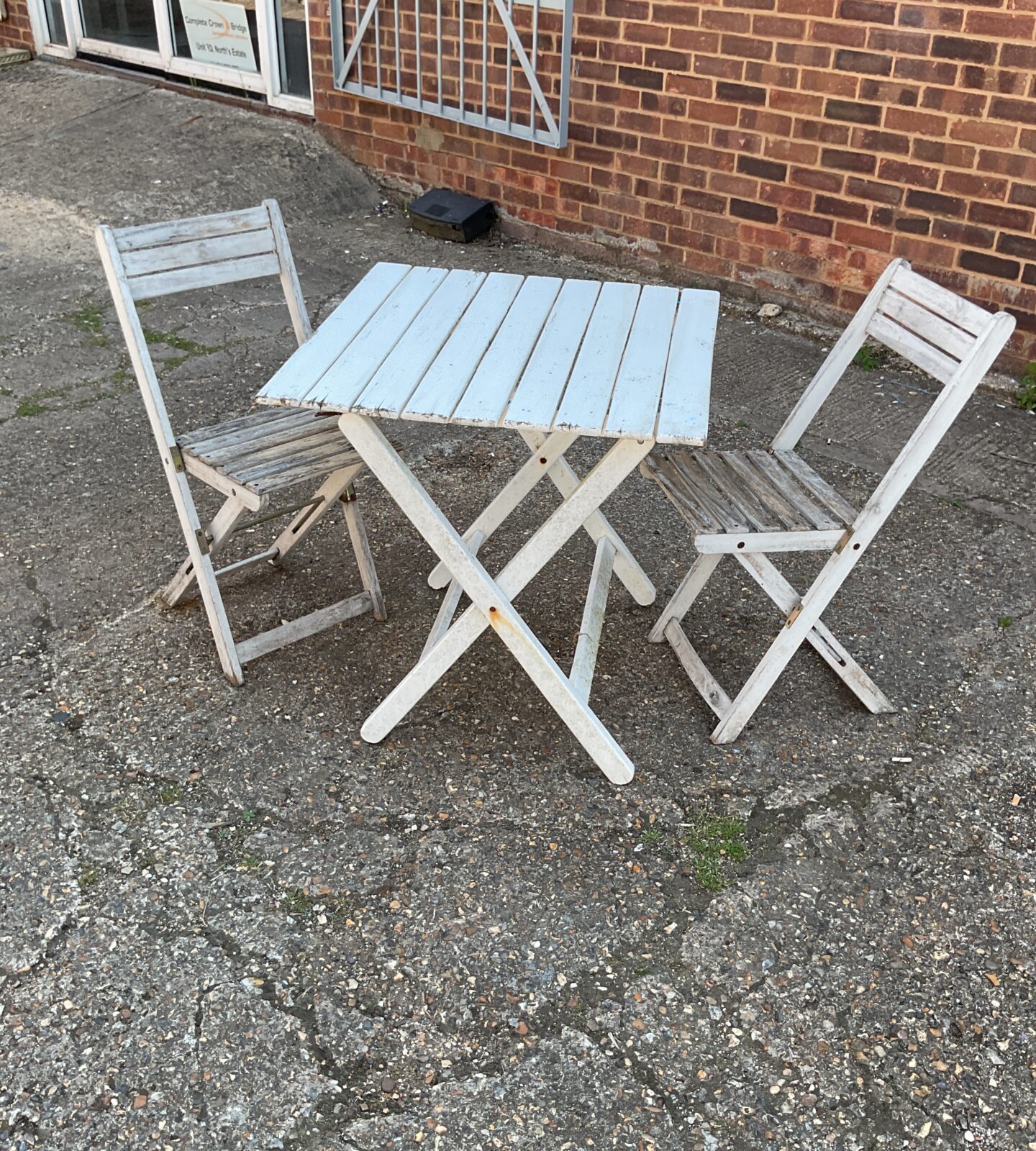 White wooden garden table with chairs