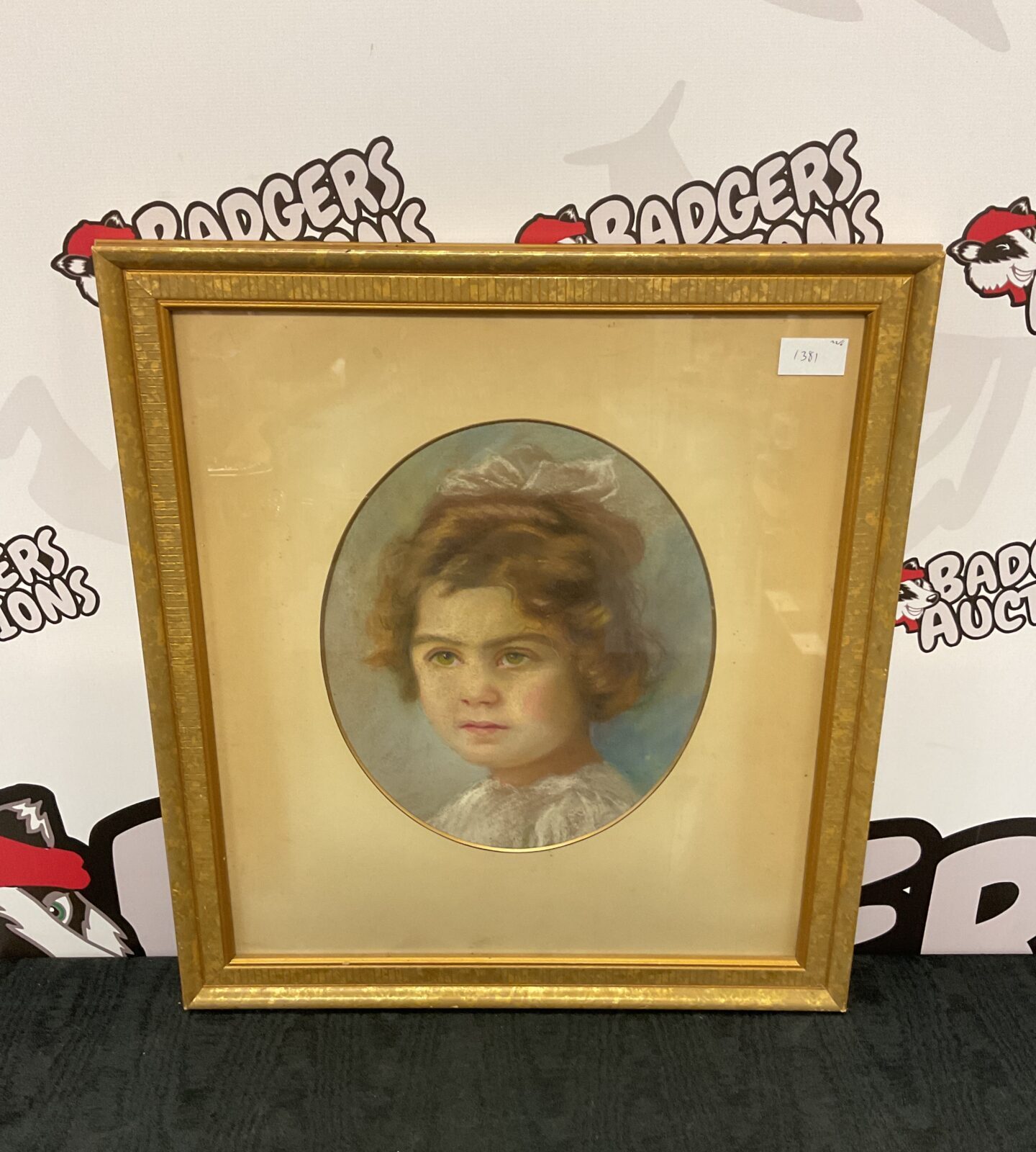 gilt framed 1930s pastel portait of a young girl with bow in hair