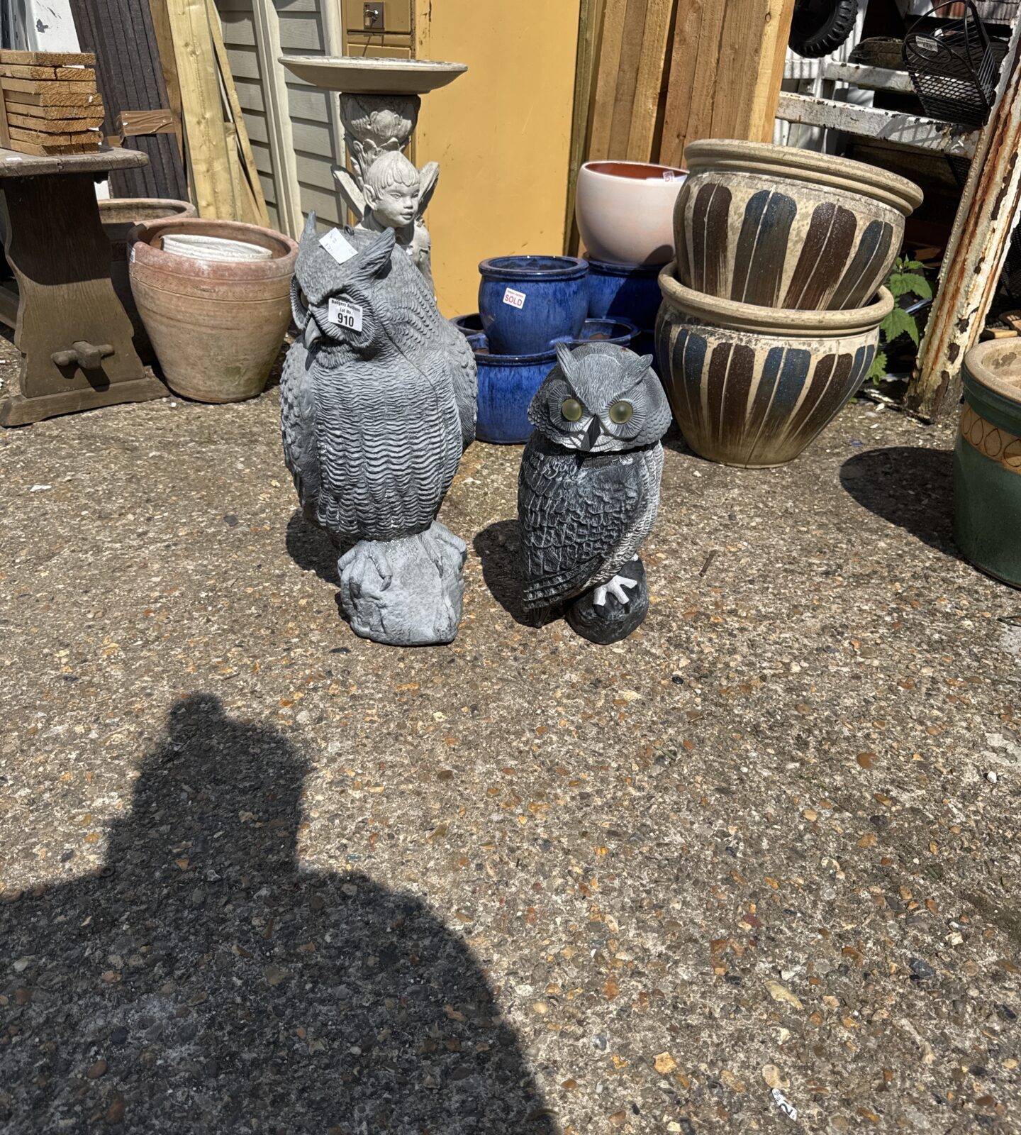 Two weighted plastic owl garden ornaments