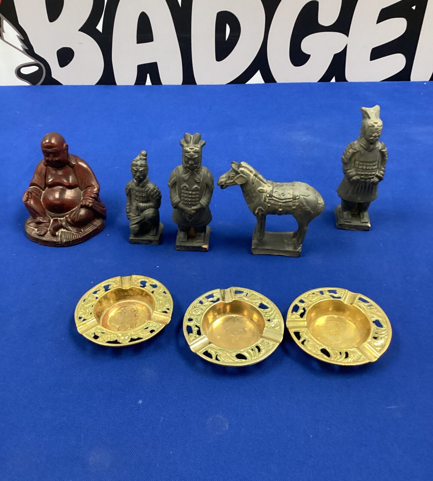 Selection of carved oriental figurines inc horse & buddha with three oriental ashtrays