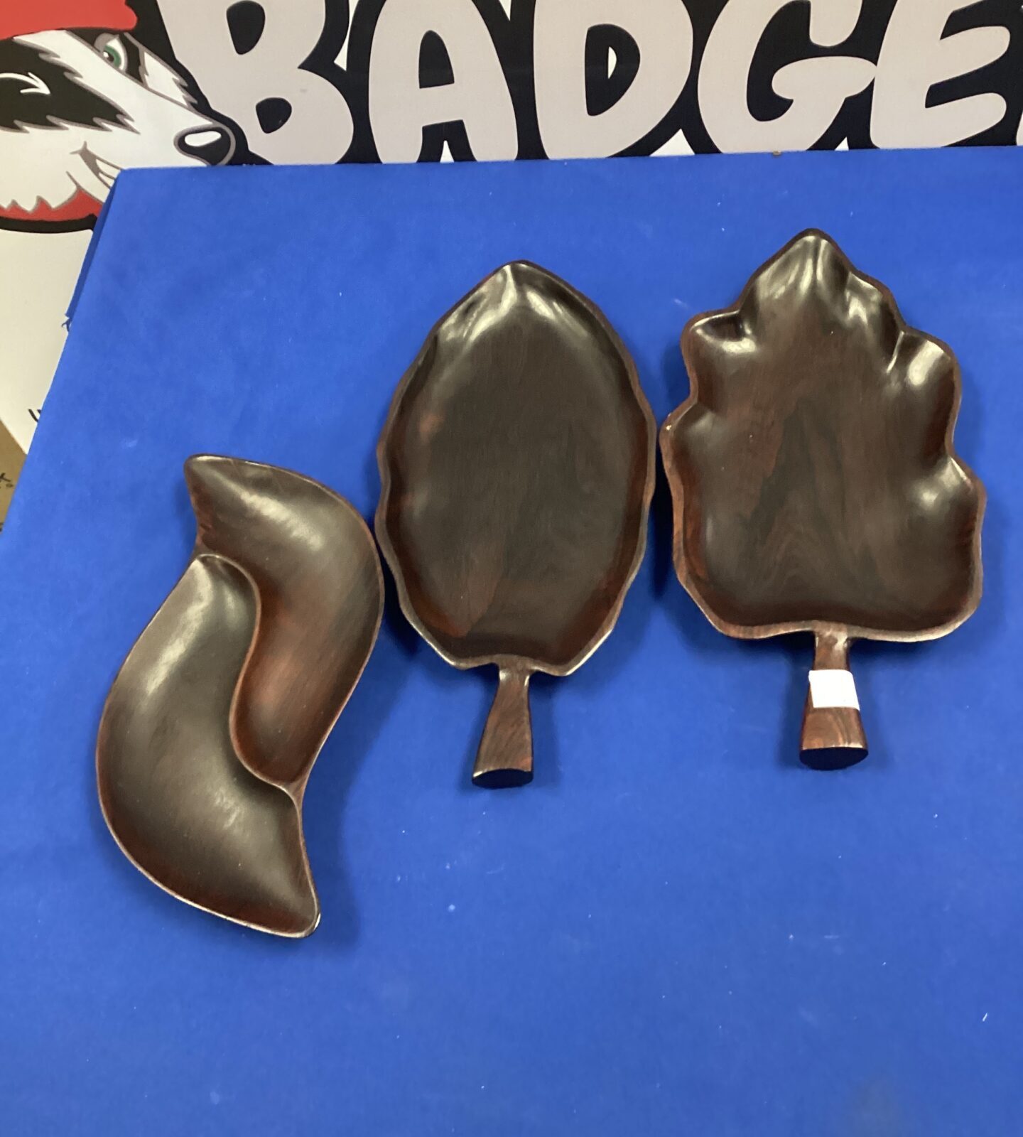 Three dark wood leaf bowls